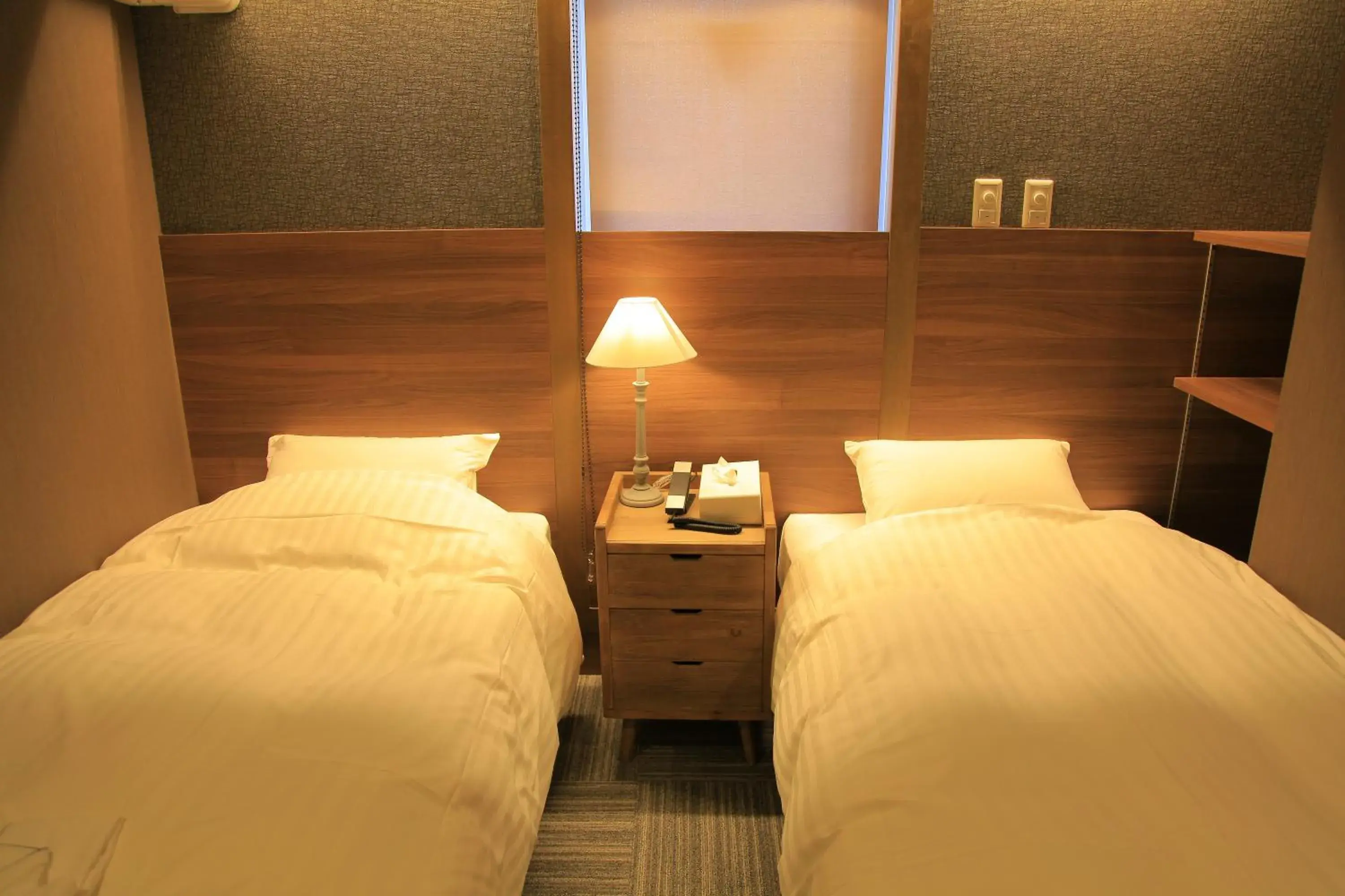Bed in Ryuka Hotel Naha