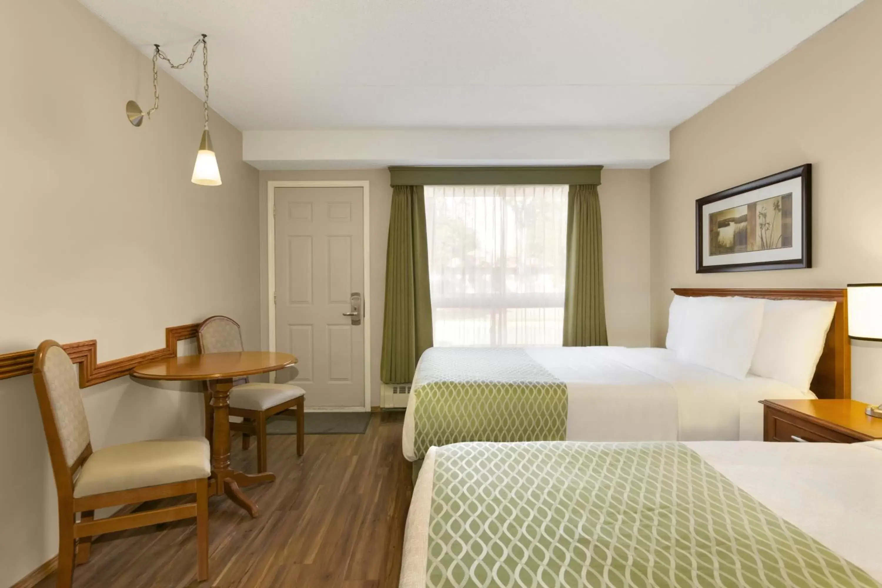 Bedroom in Colonial Square Inn & Suites