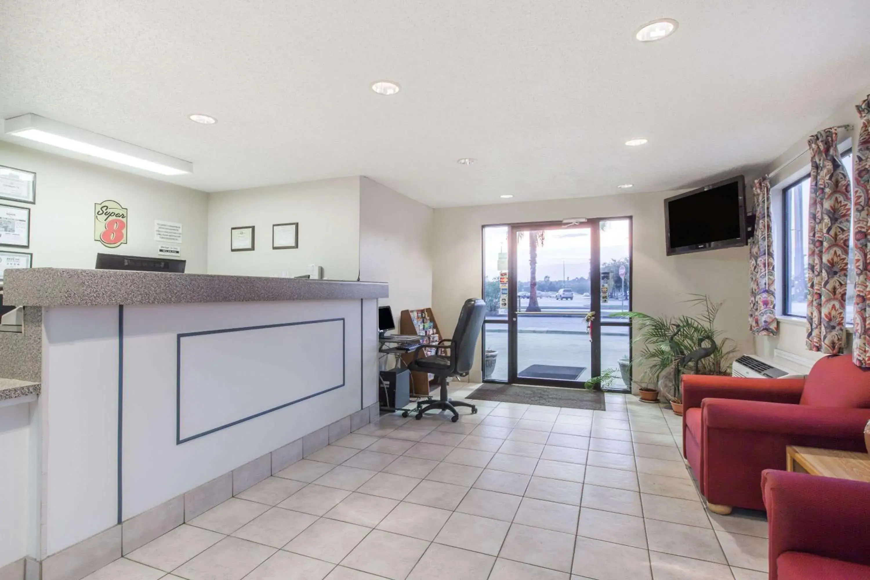 Lobby or reception in Super 8 by Wyndham Cleveland TX Lobby or reception in Super 8 by Wyndham Cleveland TX