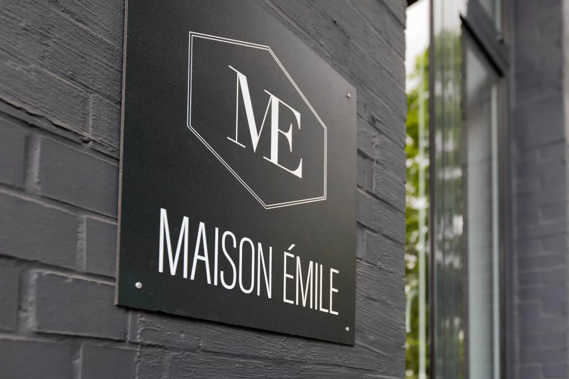 Property logo or sign in Boutique hotel Maison Emile