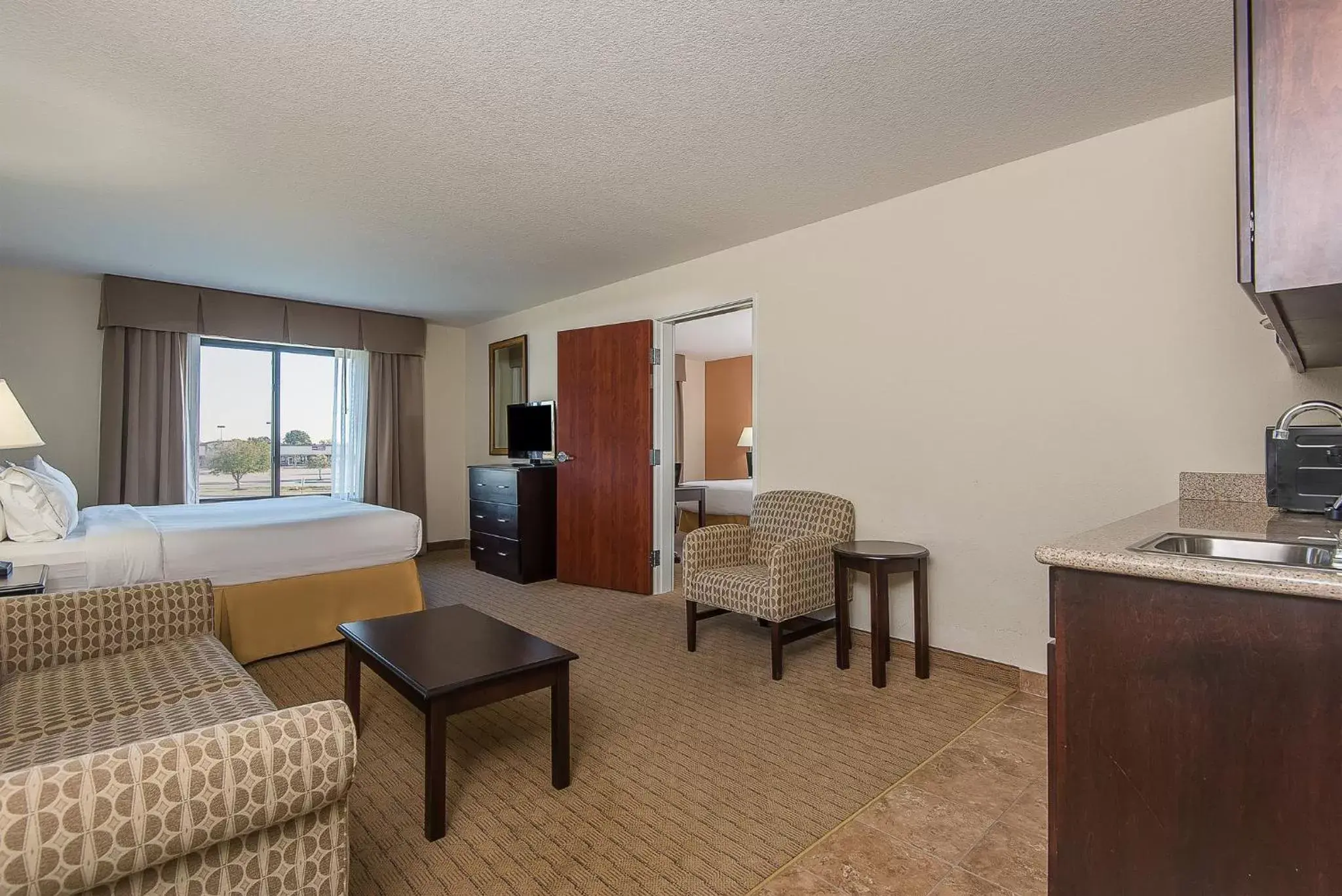 Bedroom, Seating Area in Holiday Inn Express and Suites Lafayette East, an IHG Hotel