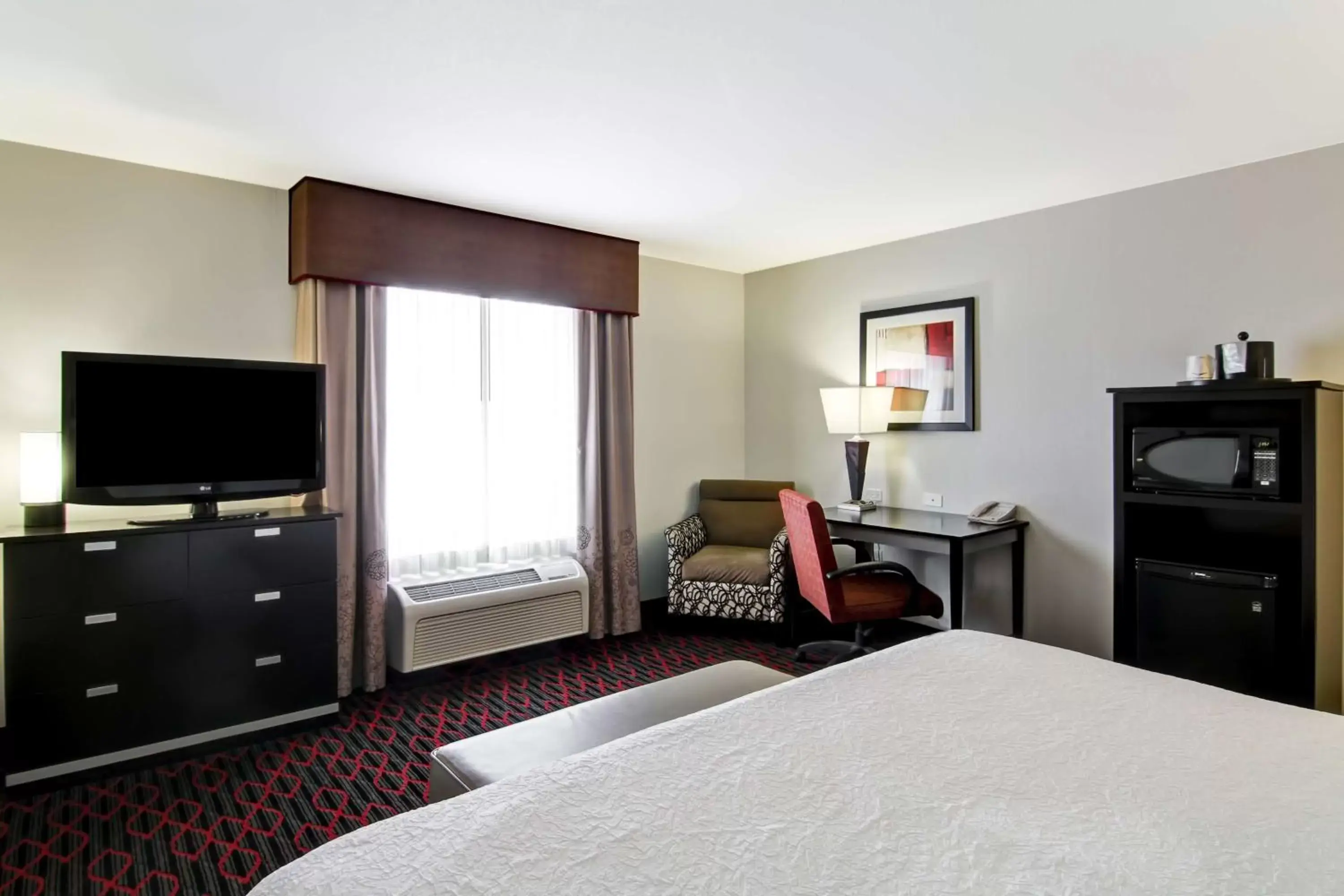 Bed, TV/Entertainment Center in Hampton Inn & Suites Red Deer