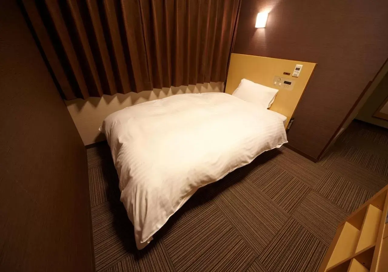 Bed in Dormy Inn Hiroshima