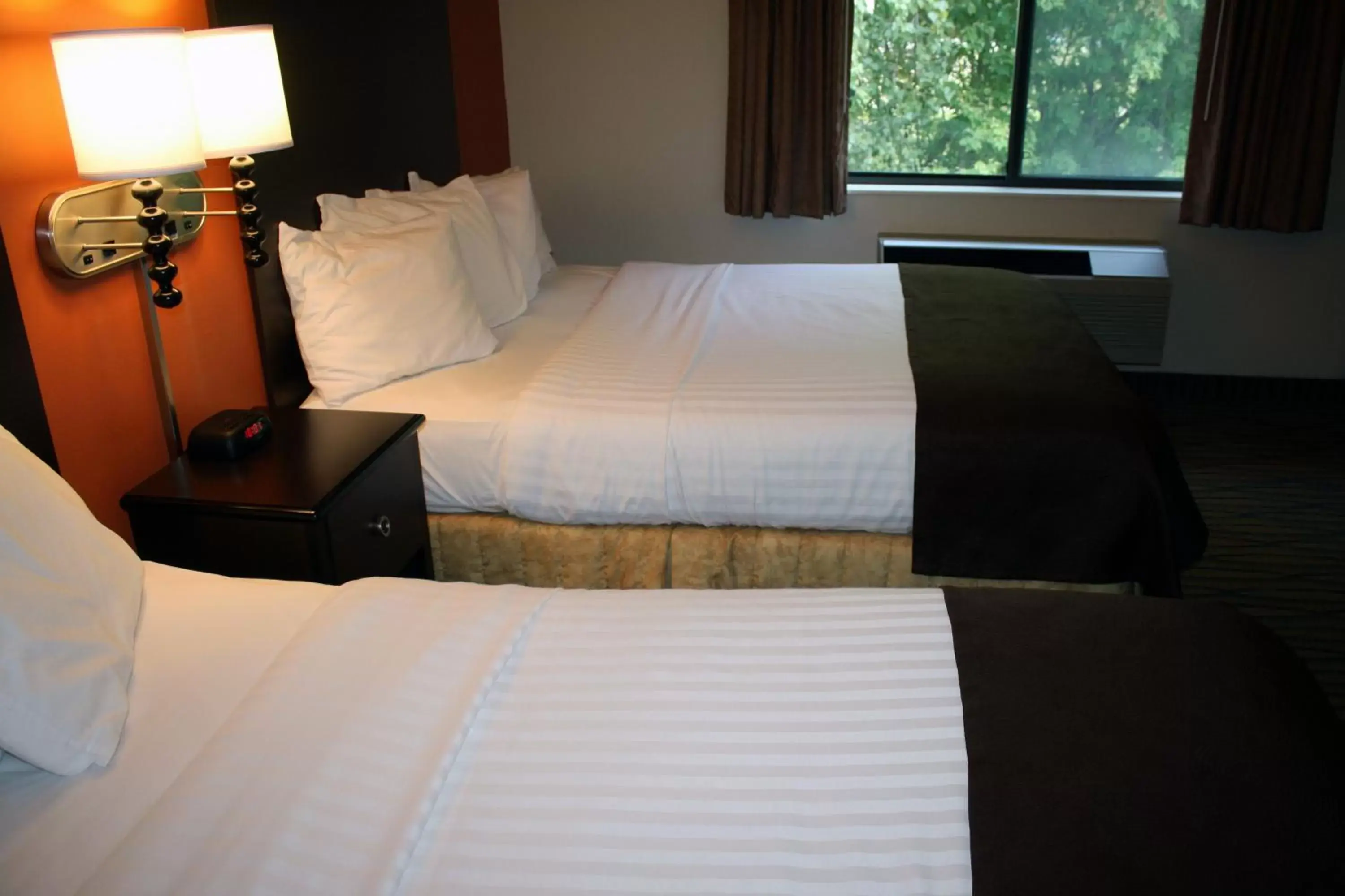 Bed in AmericInn by Wyndham Rogers