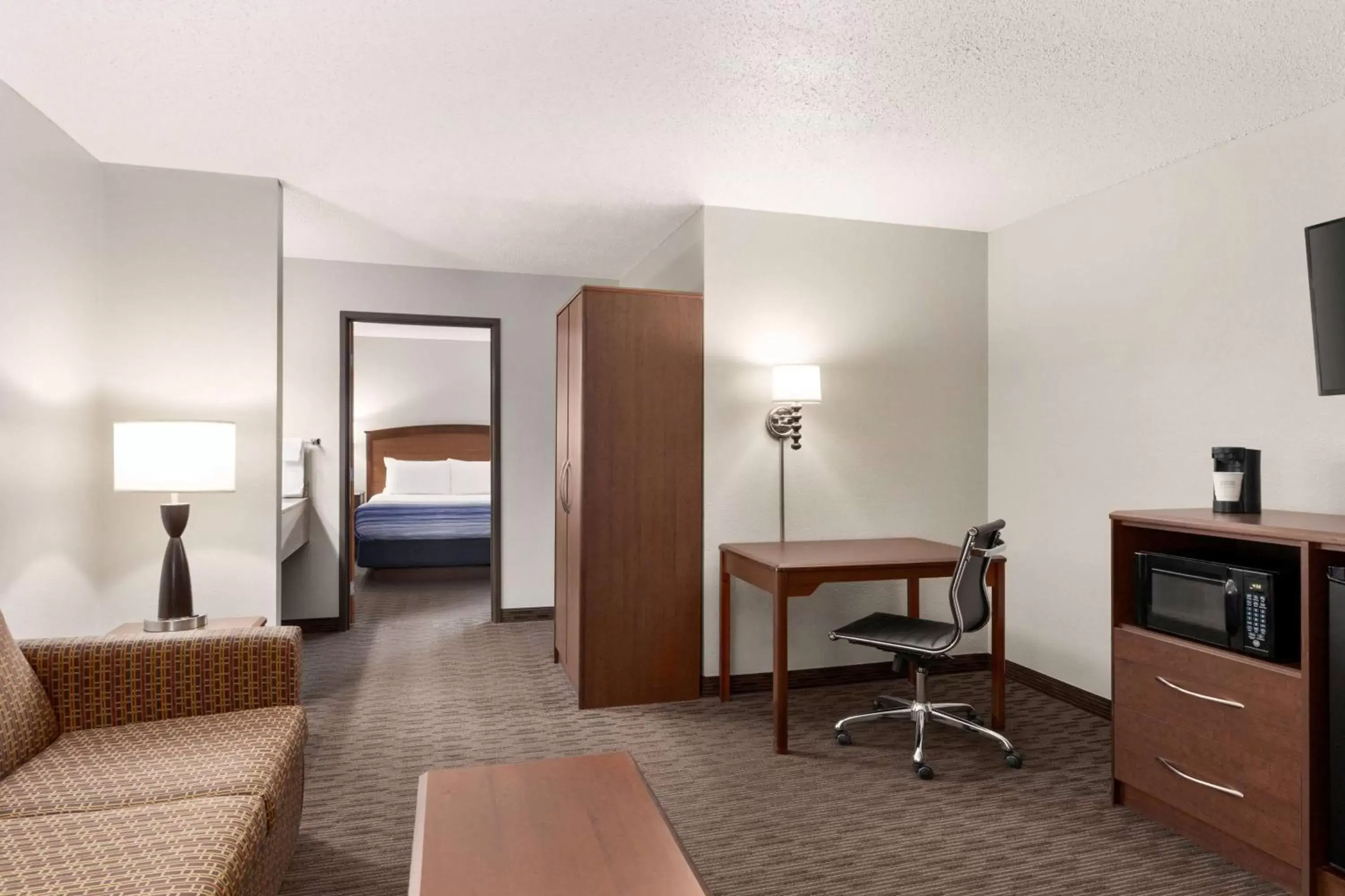 Bed, Seating Area in AmericInn by Wyndham Sauk Centre