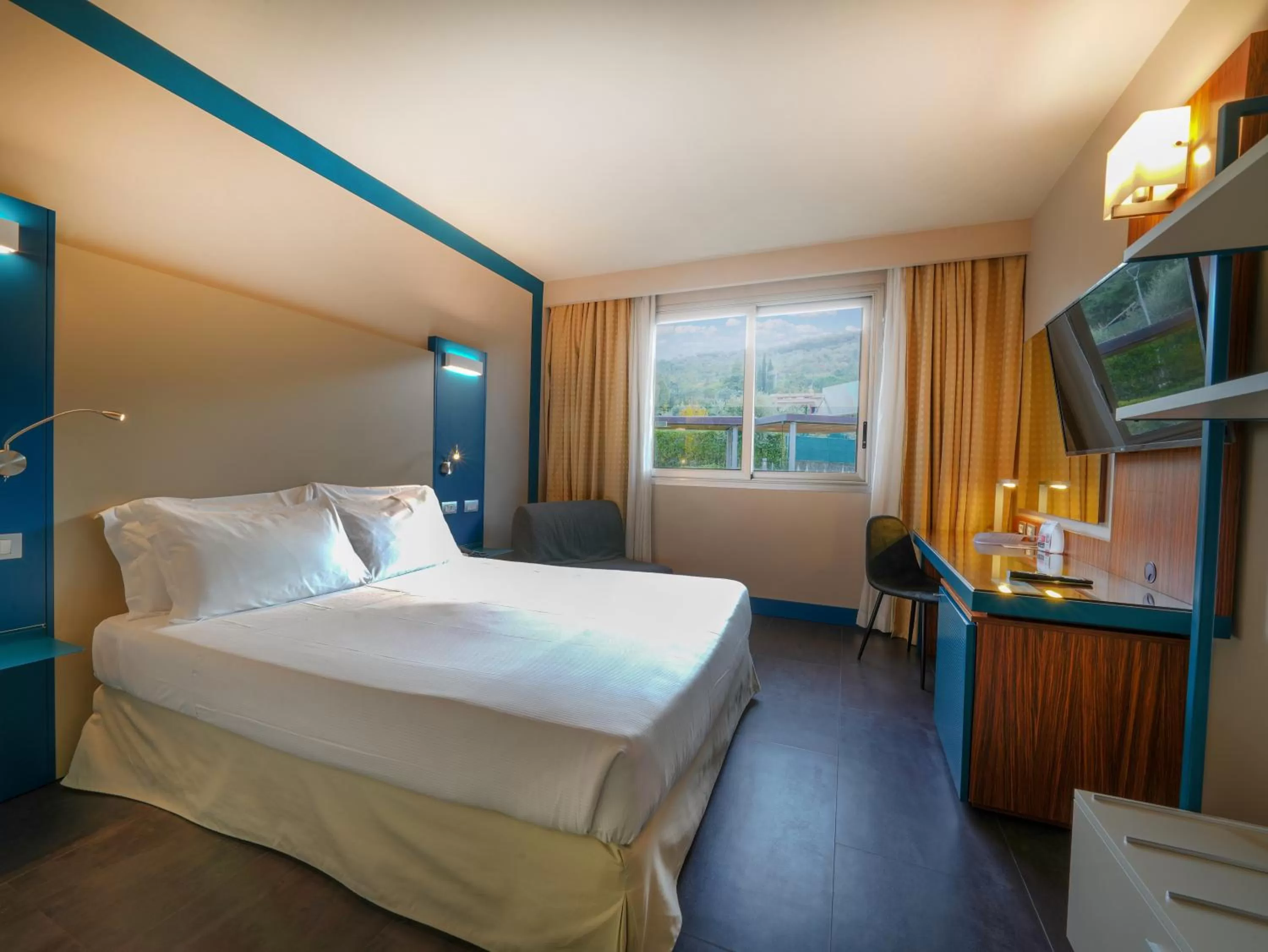 Bed in La Meridiana Bleisure Hotel