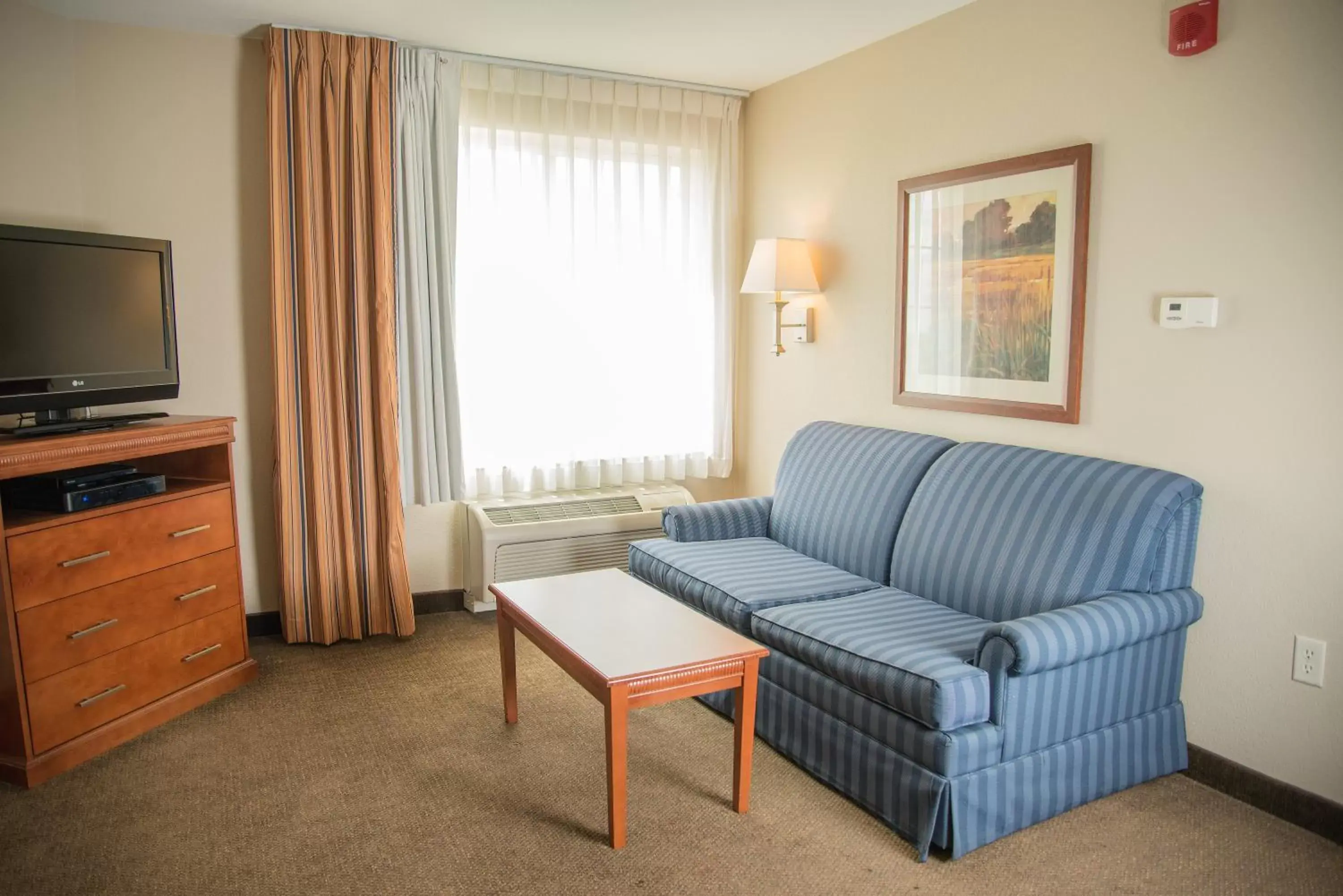 Bedroom, Seating Area in Candlewood Suites Loveland, an IHG Hotel