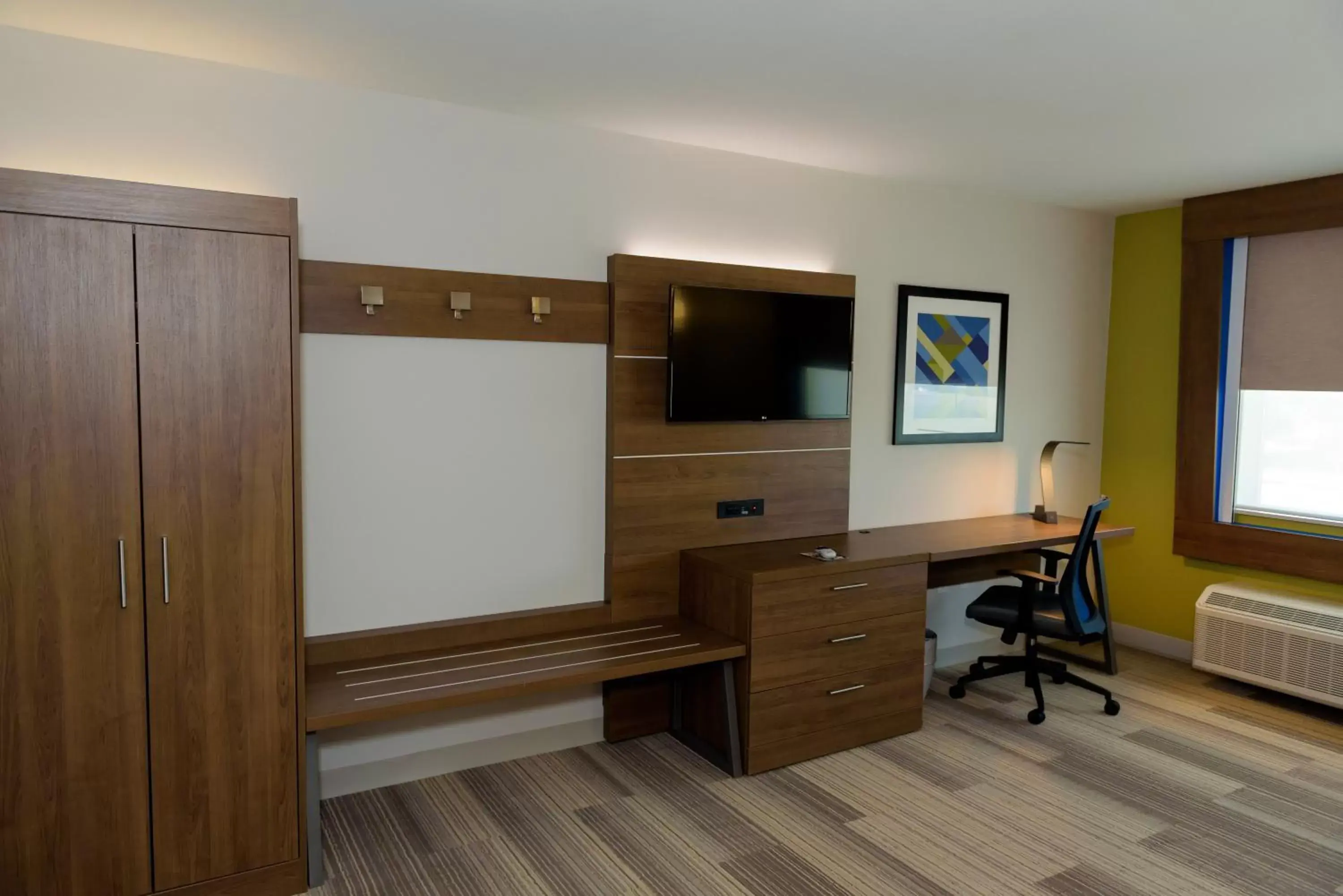 Photo of the whole room, TV/Entertainment Center in Holiday Inn Express & Suites McKinney - Frisco East, an IHG Hotel