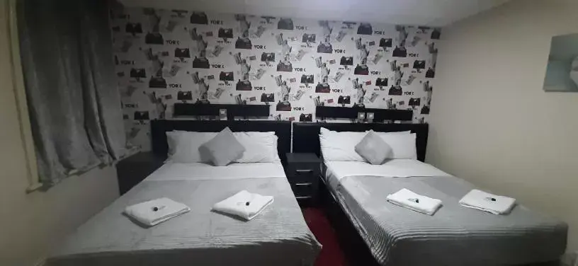 Bed in PRESTIGE PLAZA Hotel