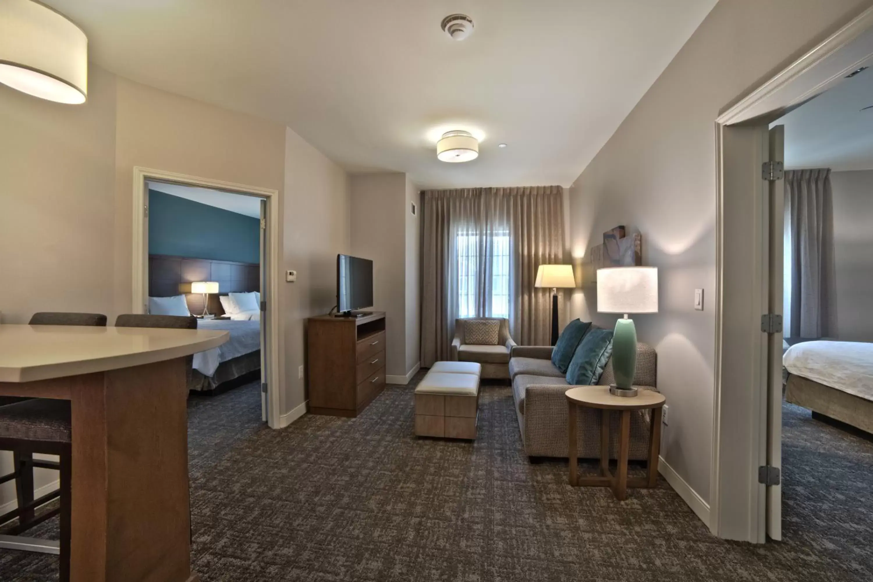 Communal lounge/ TV room, Bed in Staybridge Suites Houston - Humble Beltway 8 E by IHG Communal lounge/ TV room, Bed in Staybridge Suites Houston - Humble Beltway 8 E by IHG