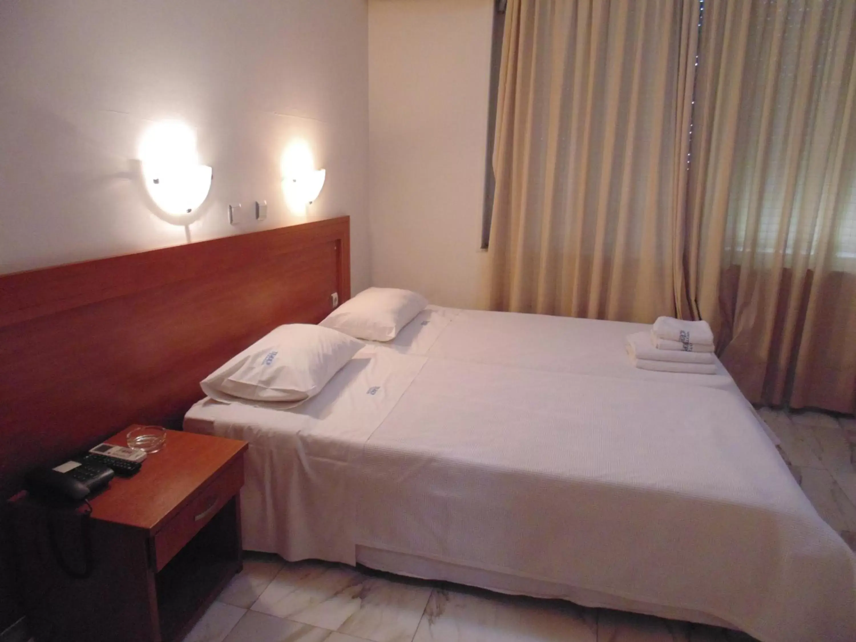 Bed in Piraeus Acropole Hotel