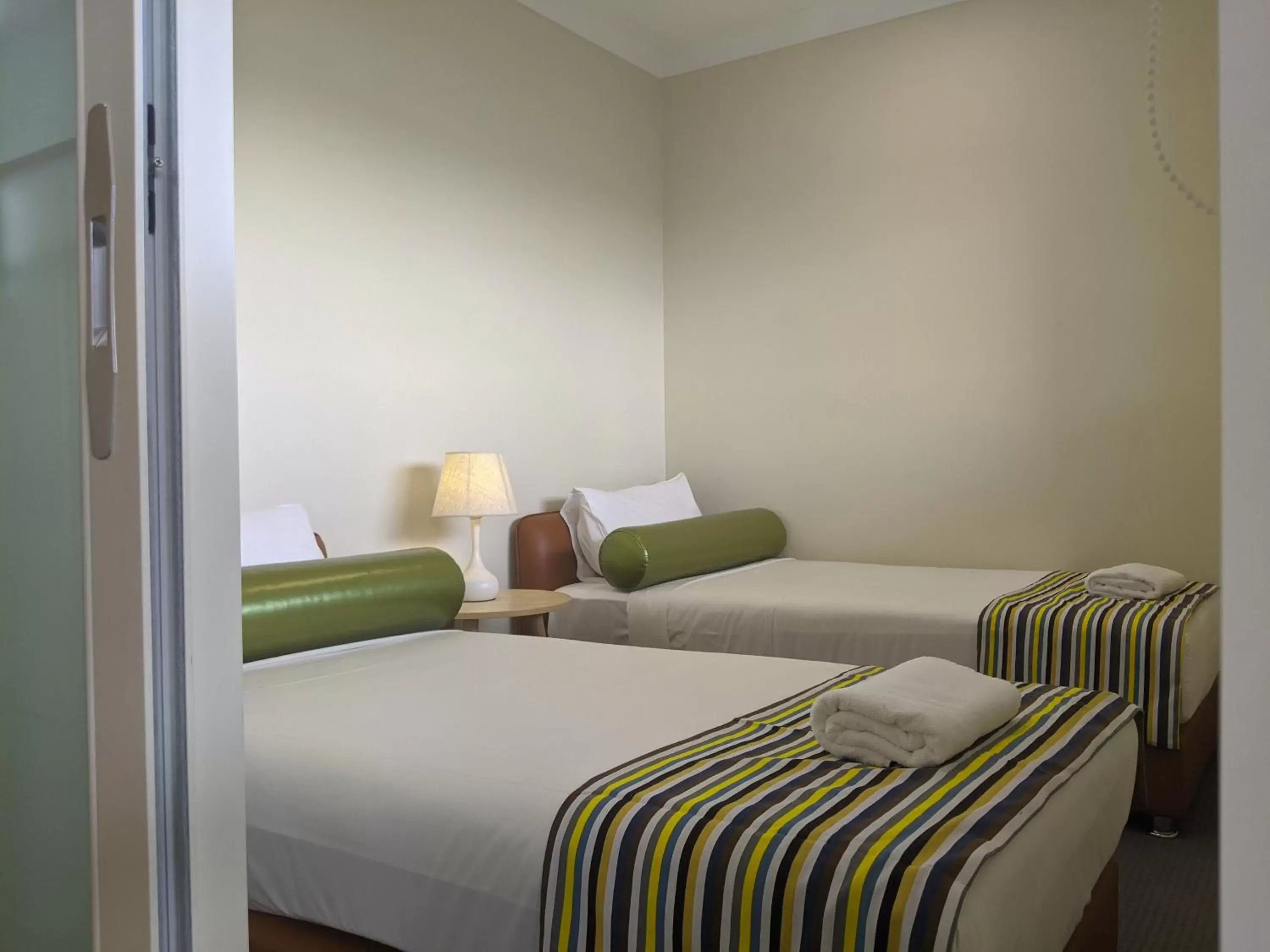 Bed in The Windsor Apartments and Hotel Rooms, Brisbane