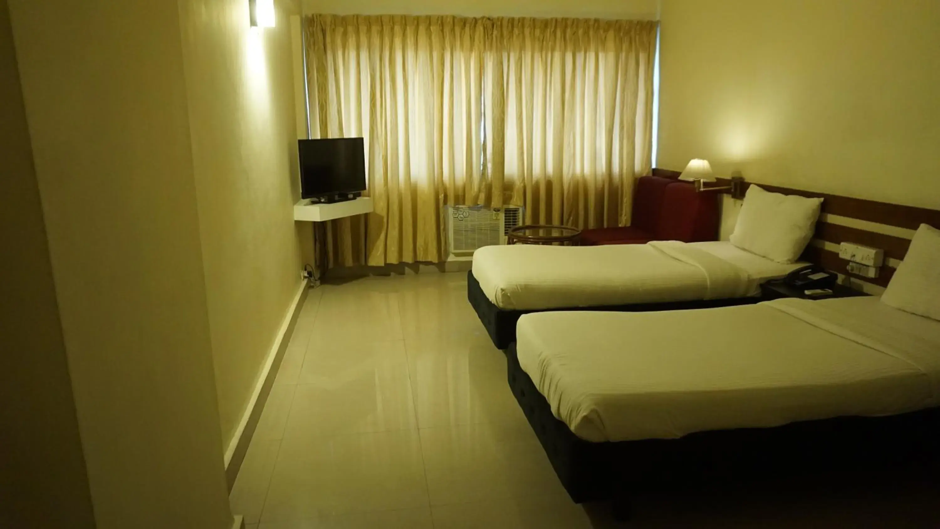 Bed in Hotel Poonja International