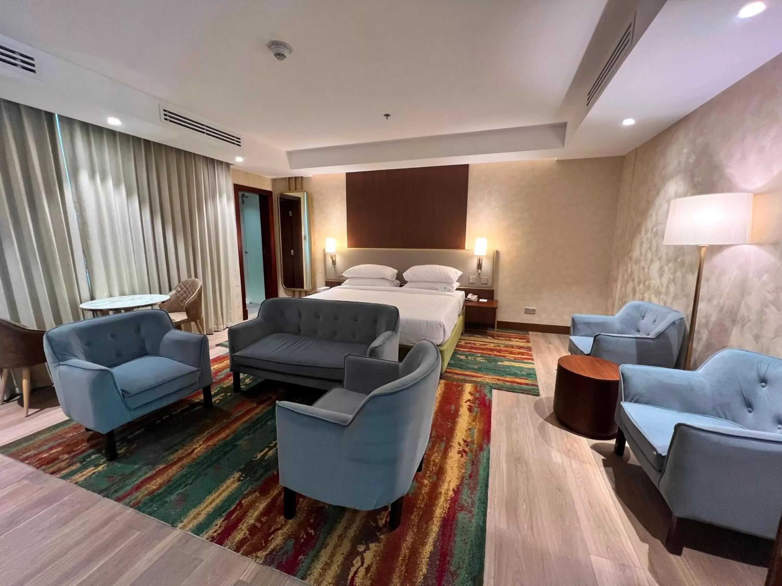 Bedroom, Seating Area in City Seasons Suites