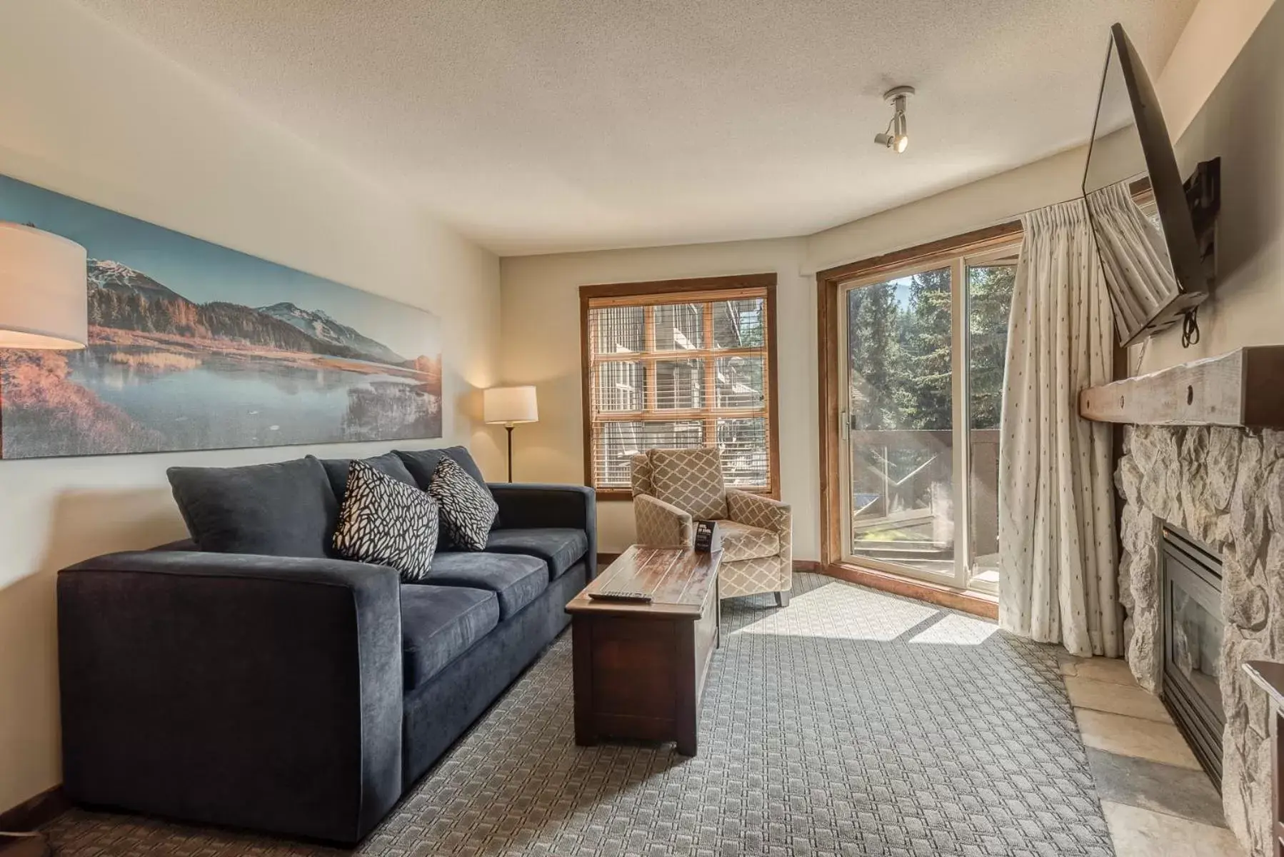 TV and multimedia, Seating Area in Blackcomb Springs Suites by CLIQUE