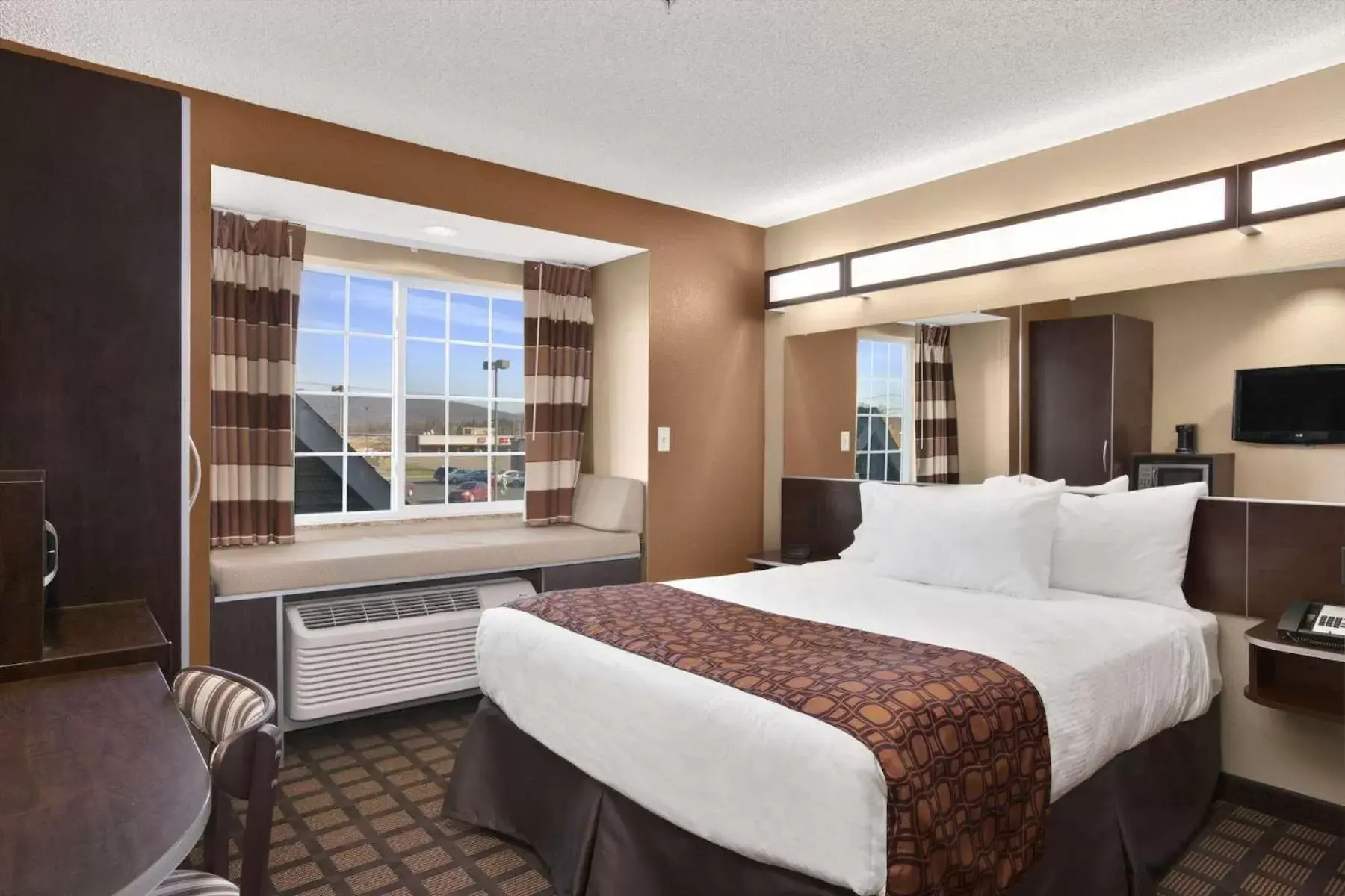 Bed in Microtel Inn & Suites-Sayre, PA