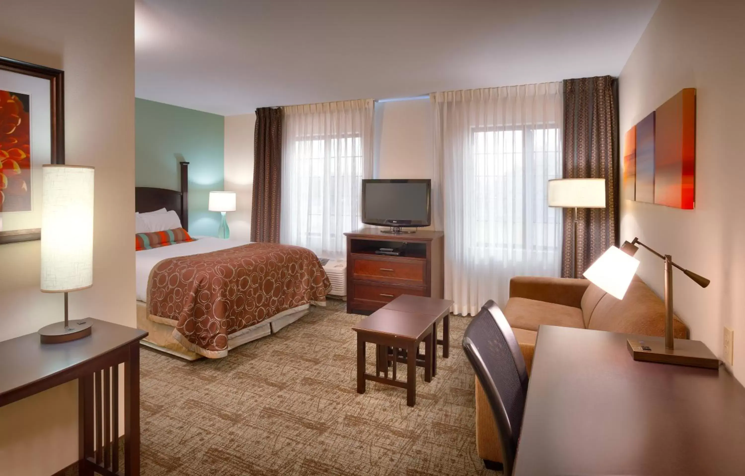 Bedroom, TV/Entertainment Center in Staybridge Suites Peoria Downtown, an IHG Hotel