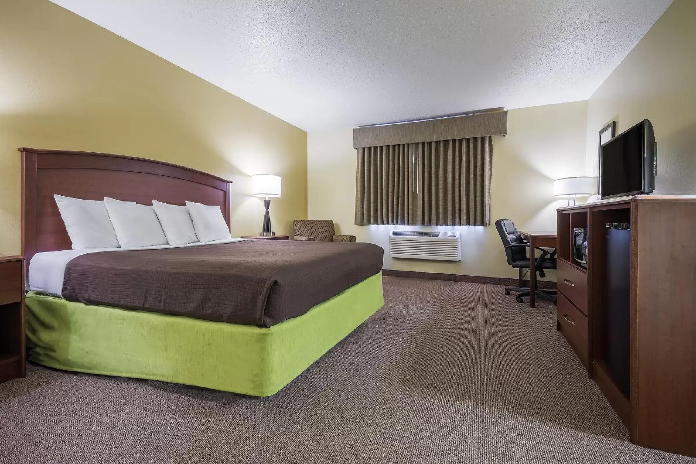 Bed in AmericInn by Wyndham Sioux Falls