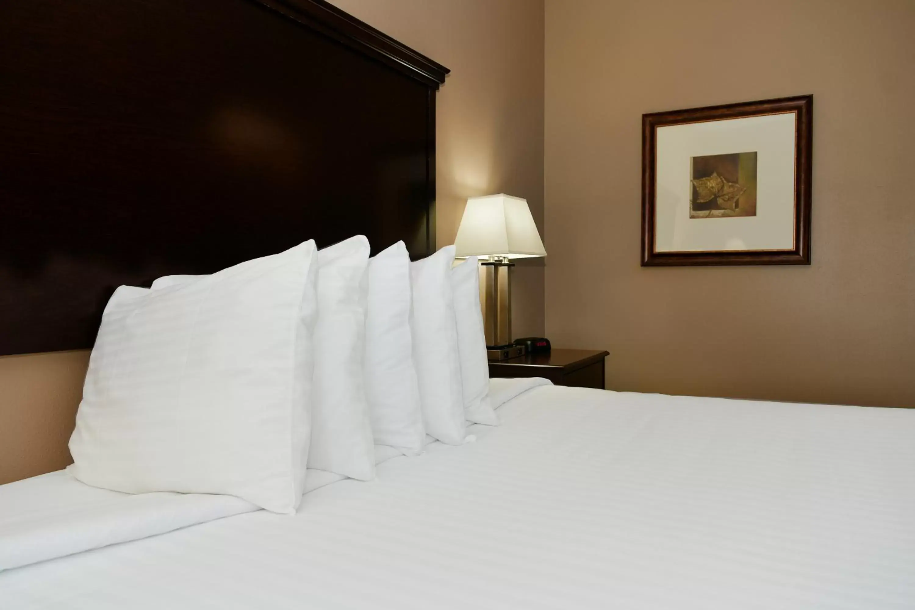 Bed in Cobblestone Inn & Suites - Denison | Majestic Hills
