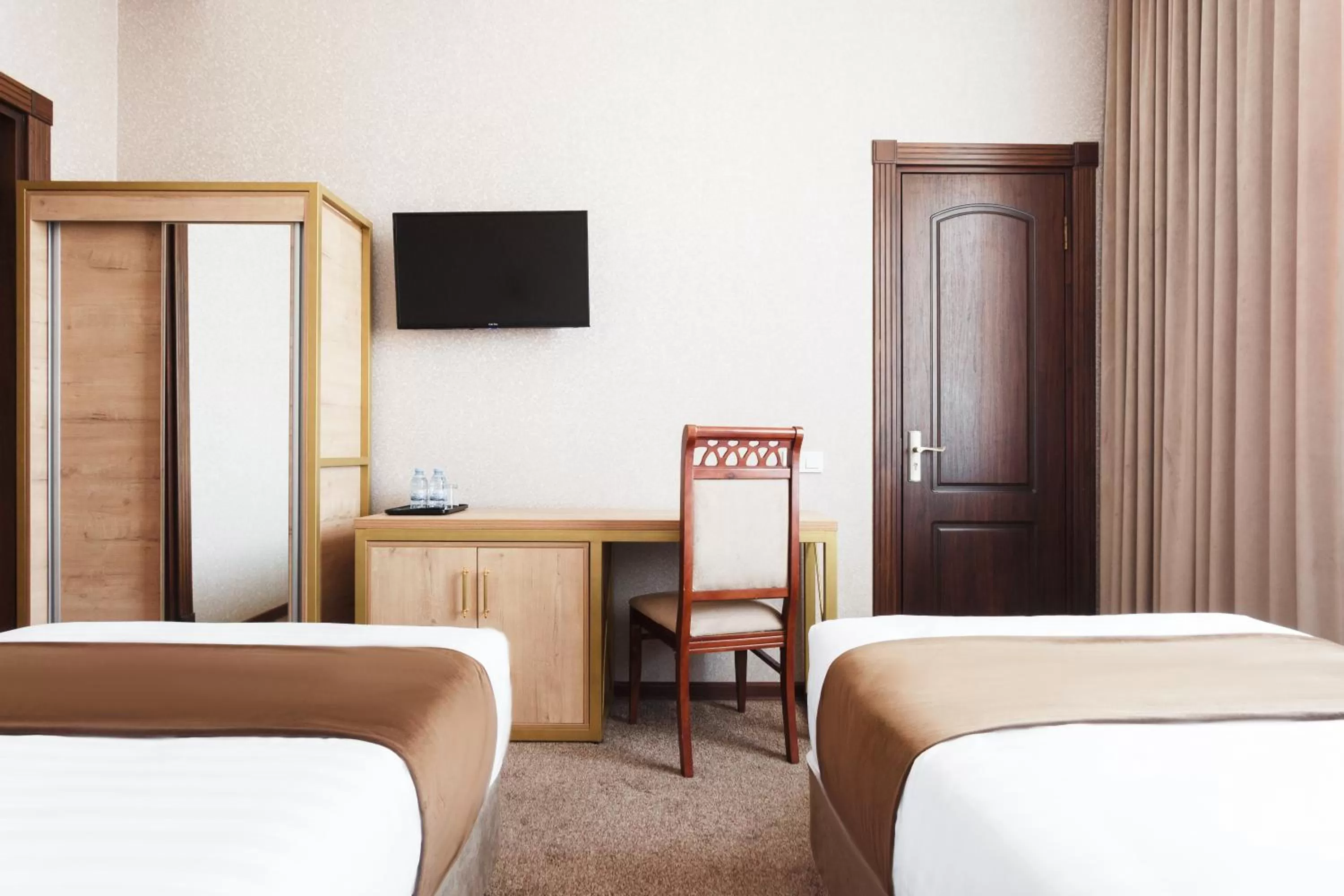 Bed in Western Suites Hotel