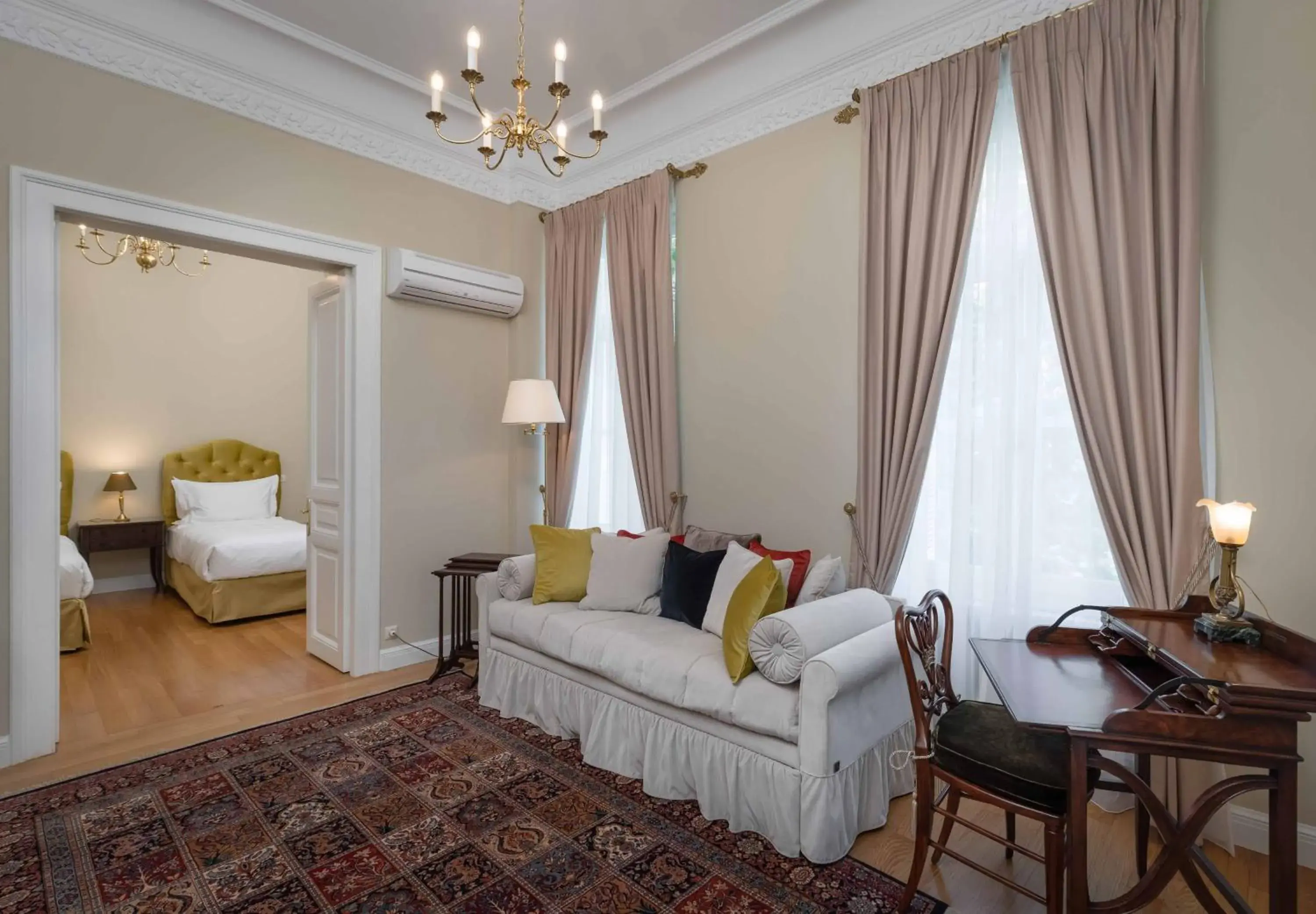 Bed, Seating Area in Noble Suites