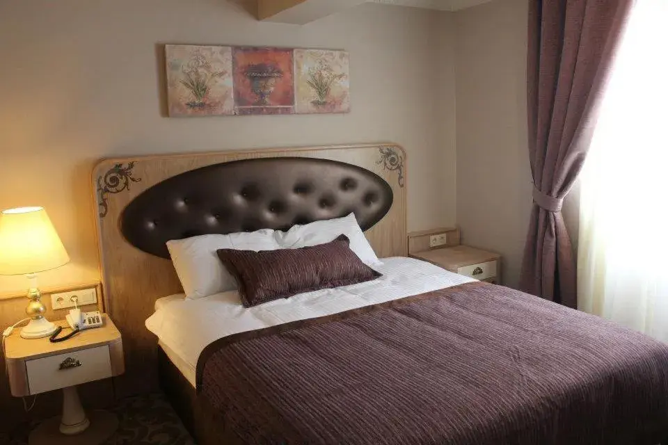 Bed in Sonno Boutique Rooms & Suites