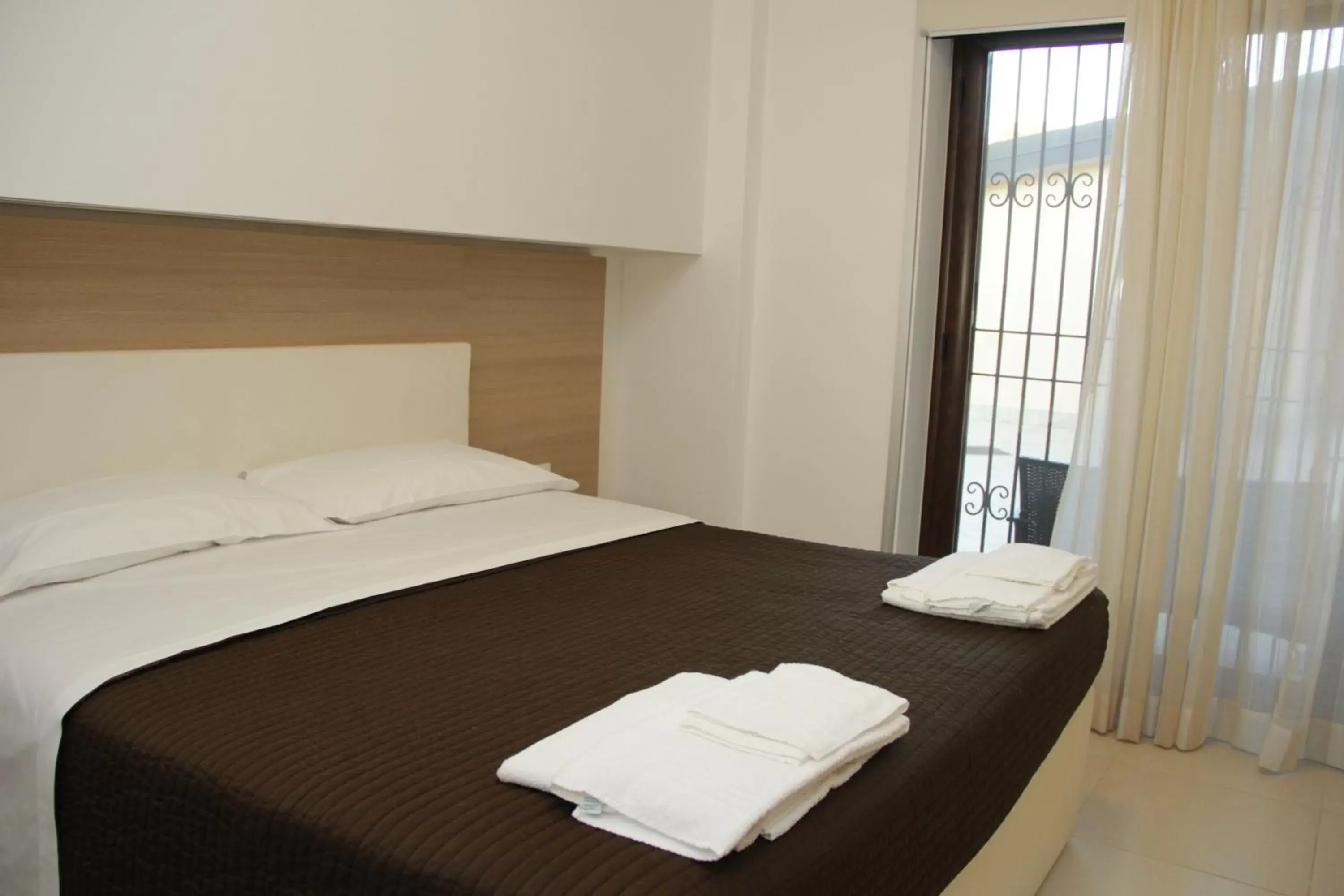 Bed in San Michele Apartments&Rooms