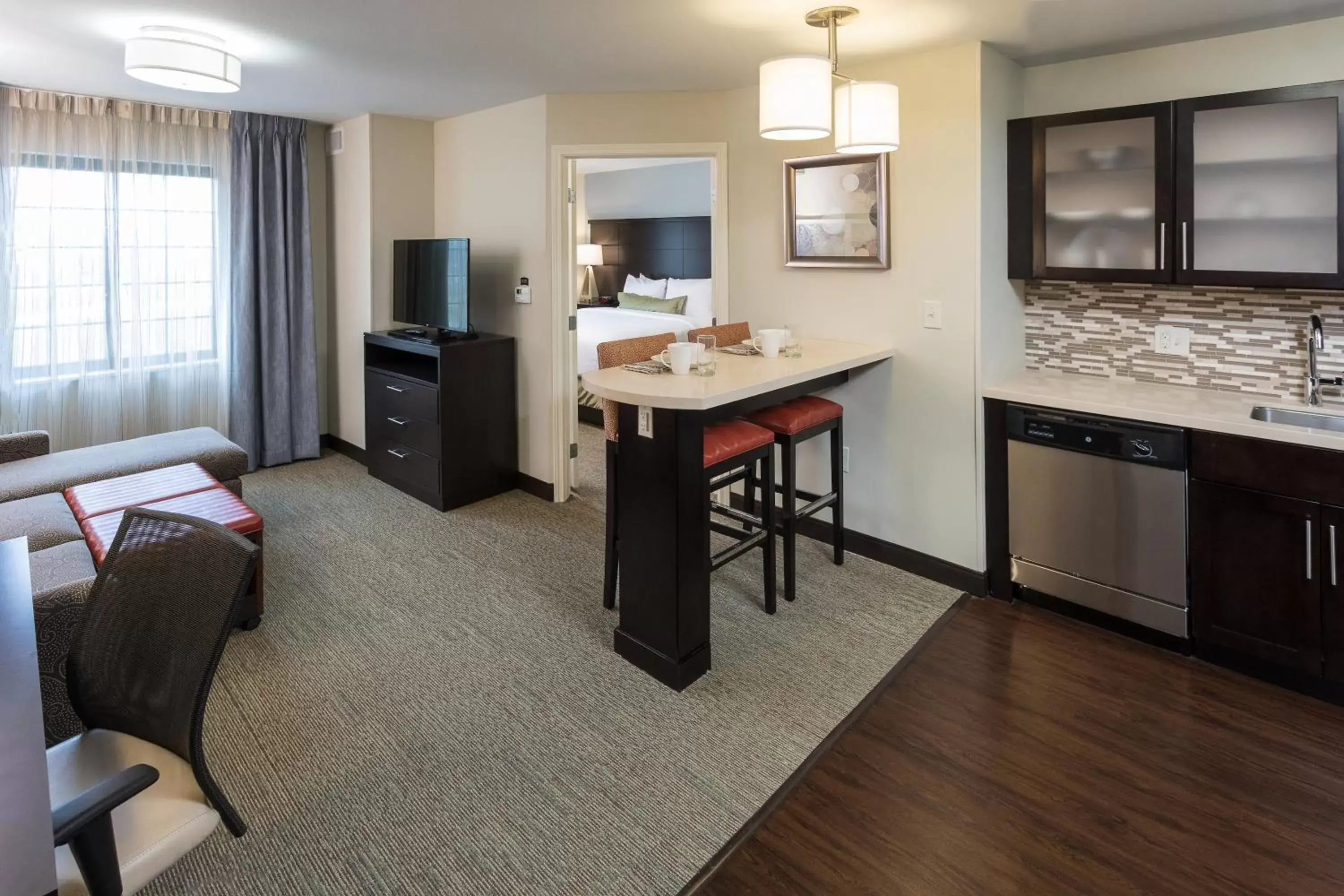 Bedroom, Kitchen/Kitchenette in Staybridge Suites Omaha West, an IHG Hotel