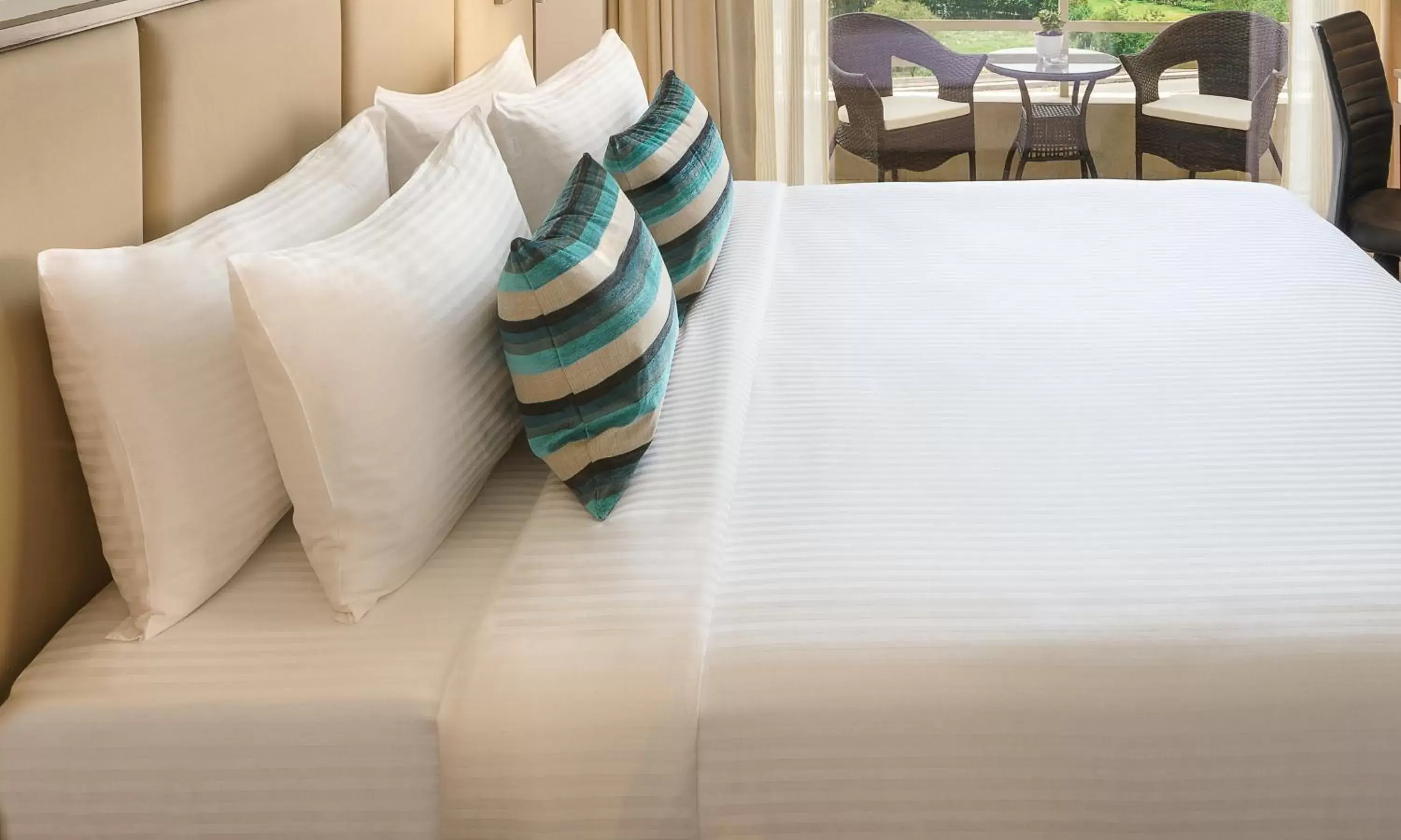Bed in Sandal Suites by Lemon Tree Hotels