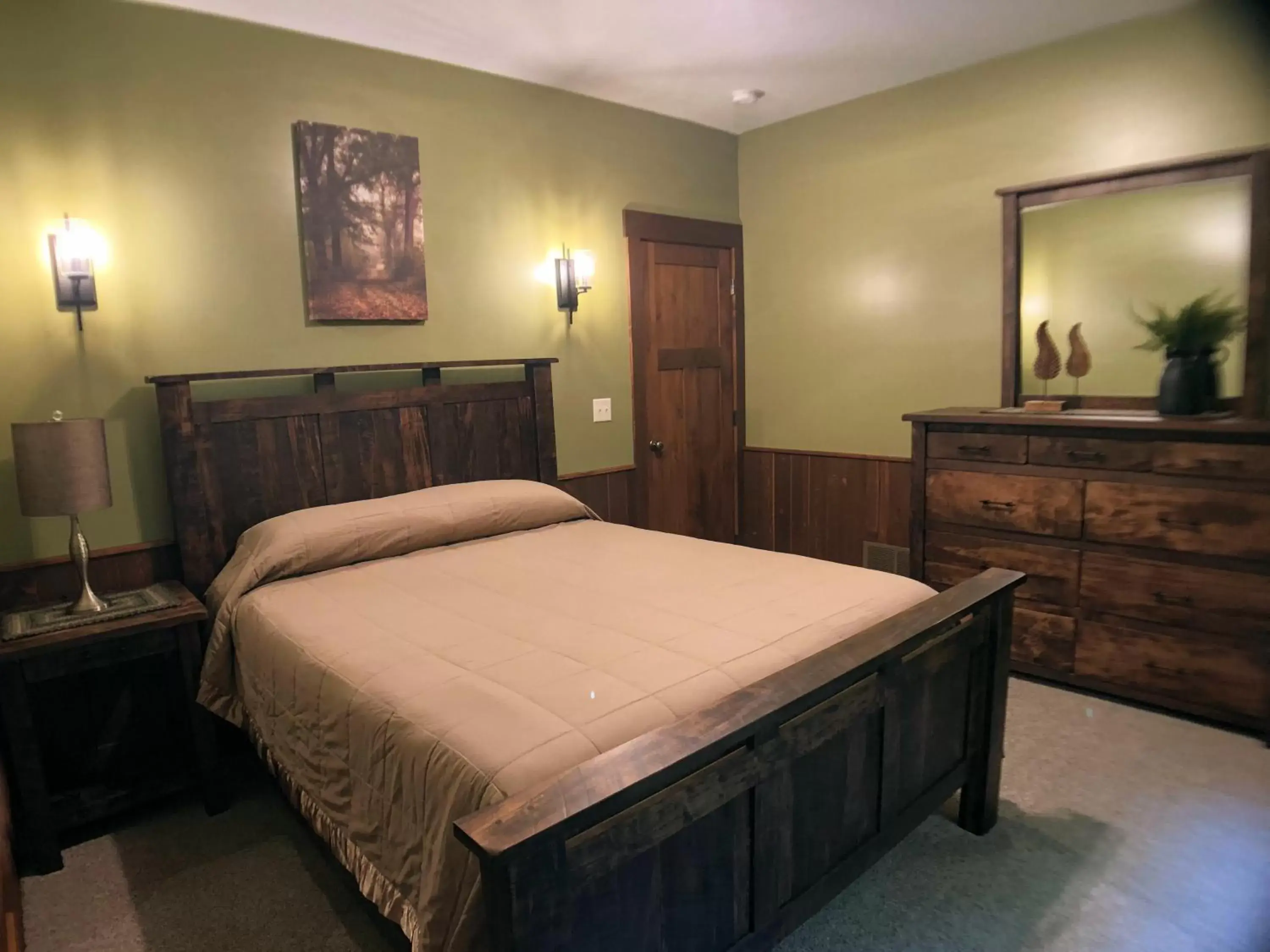 Bed in Sojourner's Lodge & Log Cabin Suites