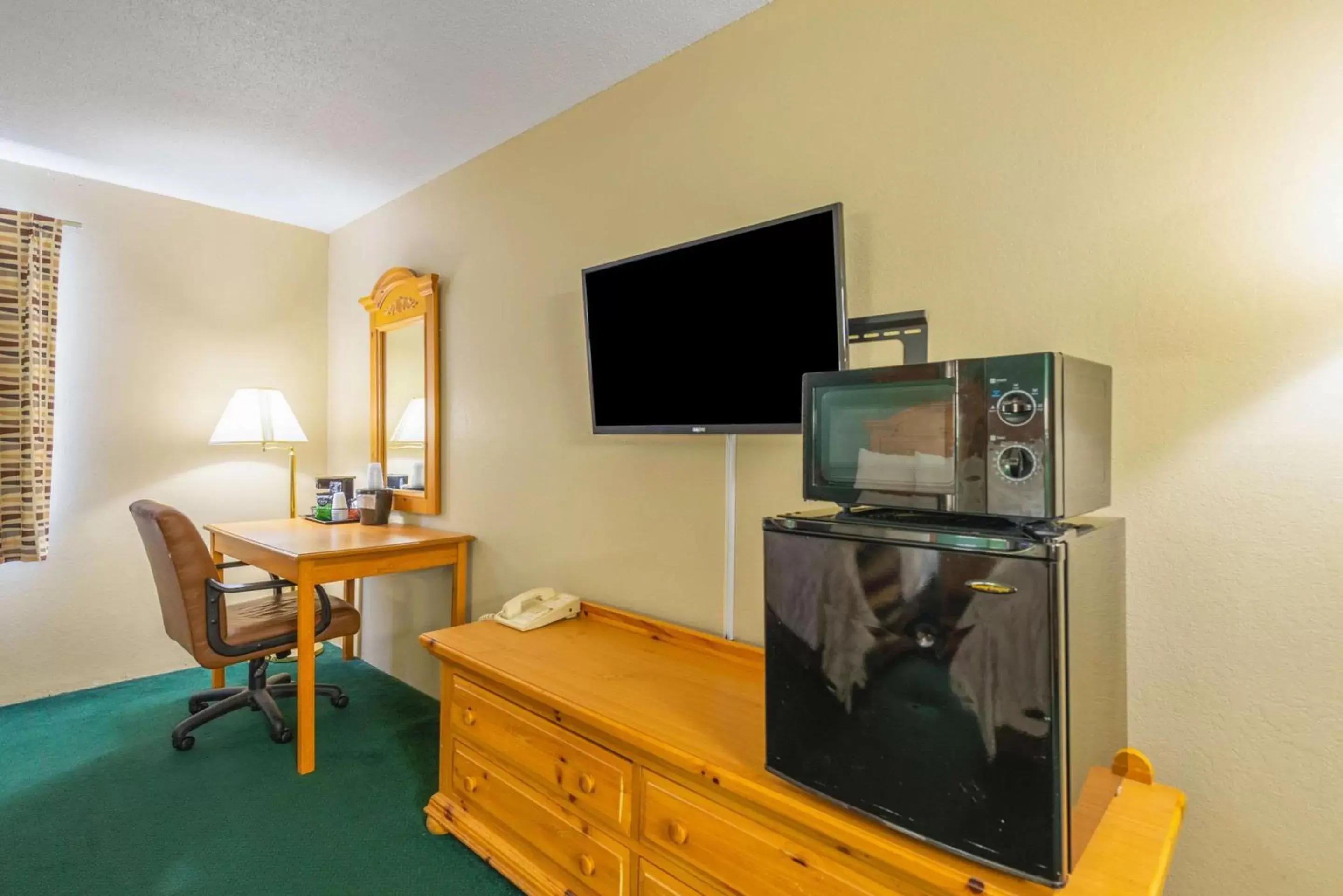 Photo of the whole room, TV/Entertainment Center in Rodeway Inn