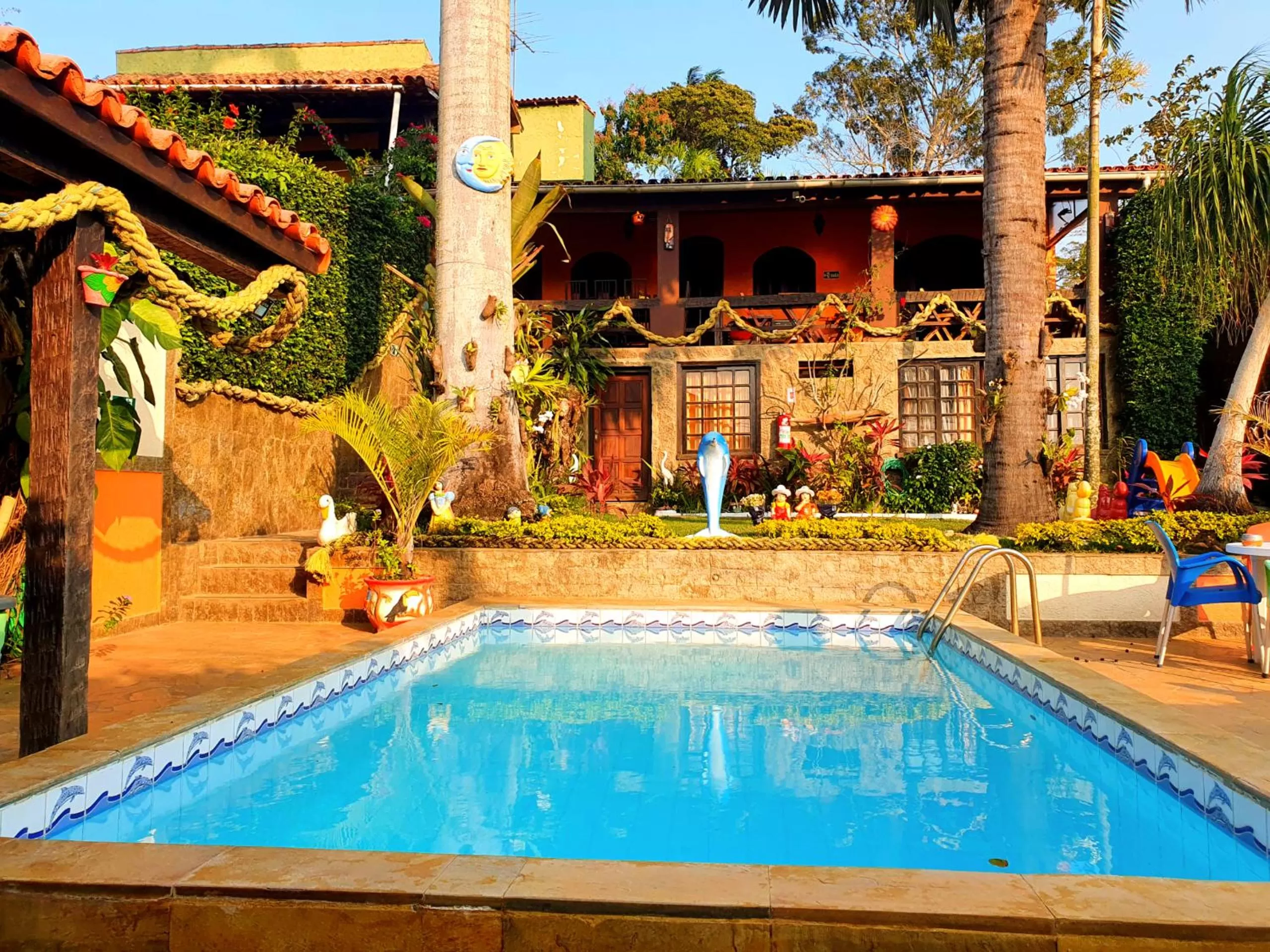 Swimming pool in Suítes Casa do Barão