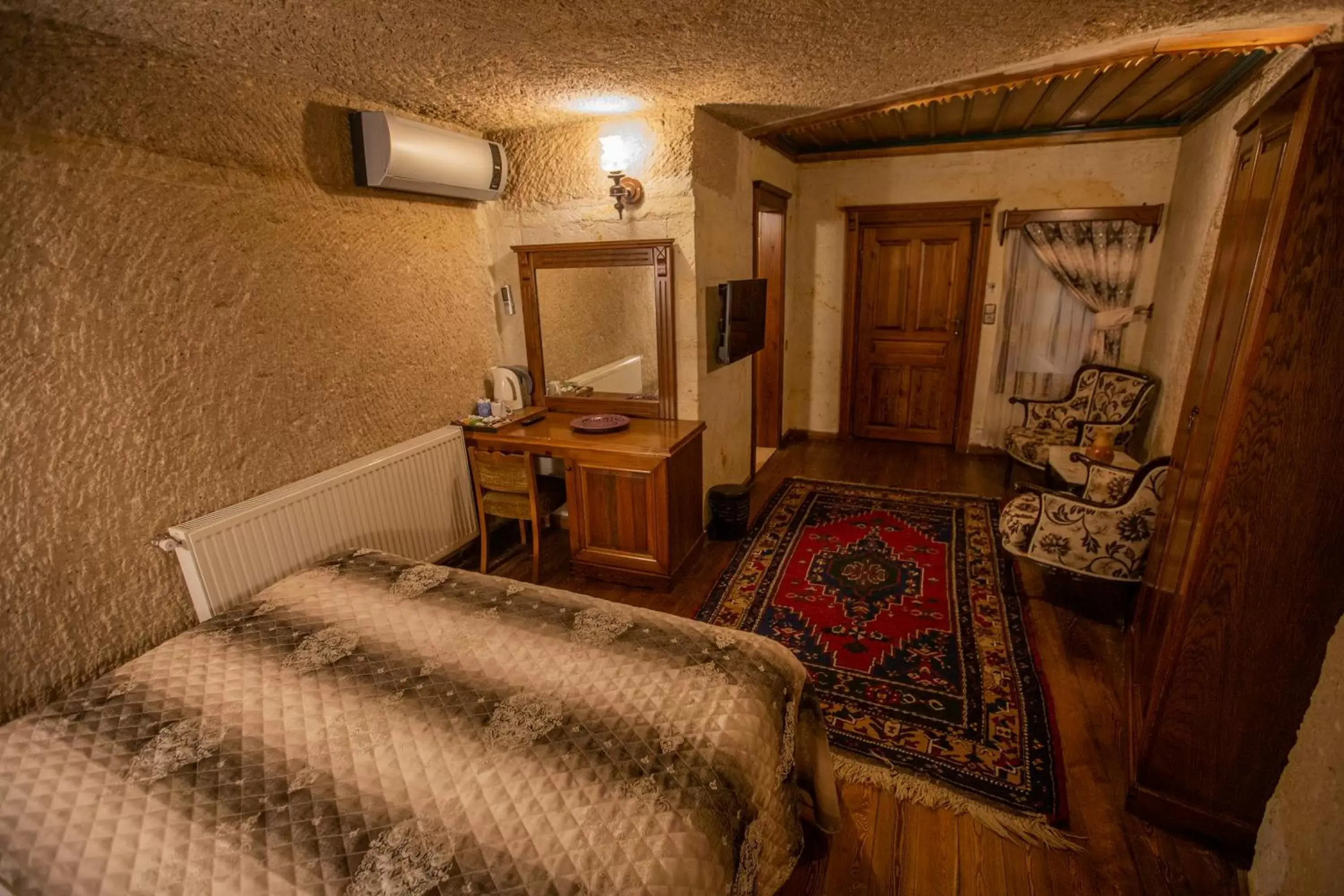 Photo of the whole room, Bed in Stone House Cave Hotel