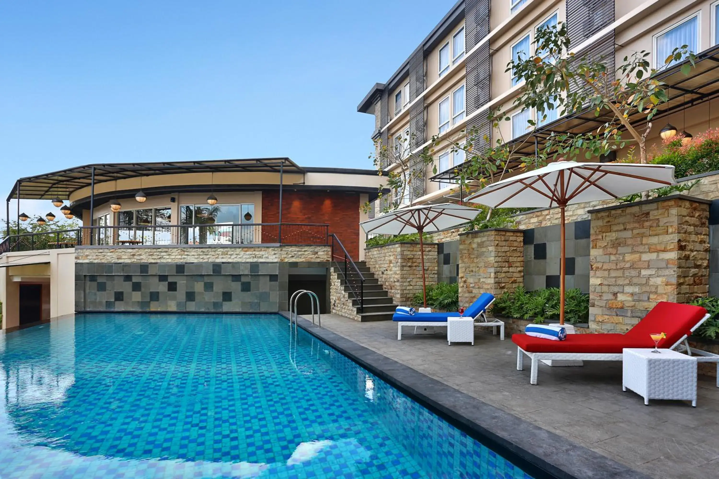 Swimming pool, Property Building in Golden Tulip Essential Denpasar Hotel