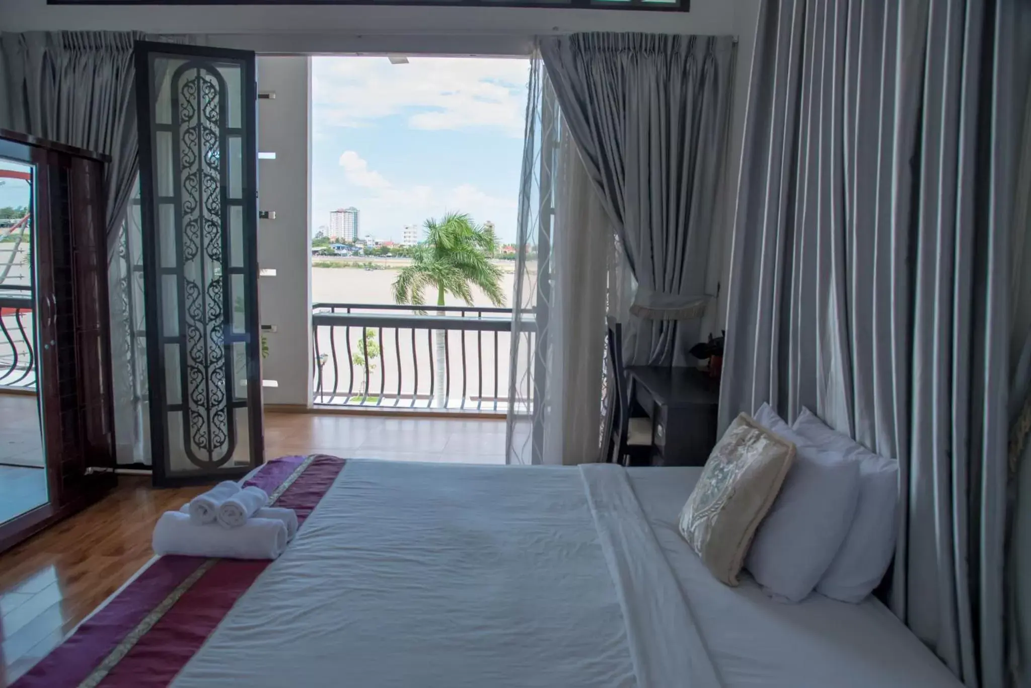 Balcony/Terrace, Bed in New Season Riverside Hotel Balcony/Terrace, Bed in New Season Riverside Hotel