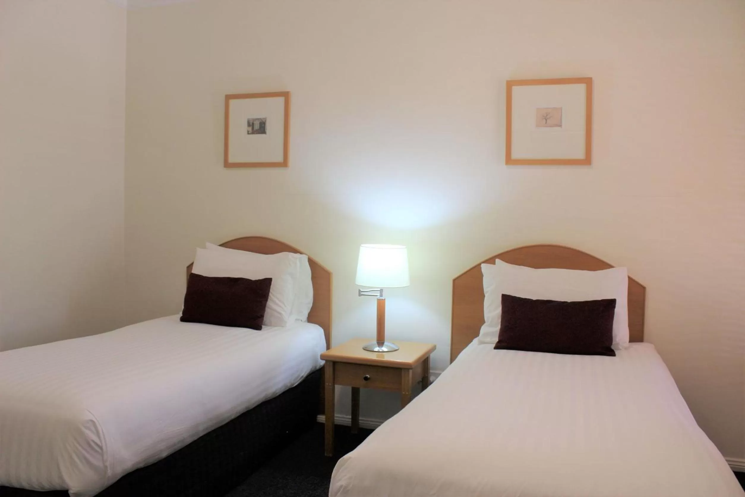 Bed in Carlyle Suites & Apartments