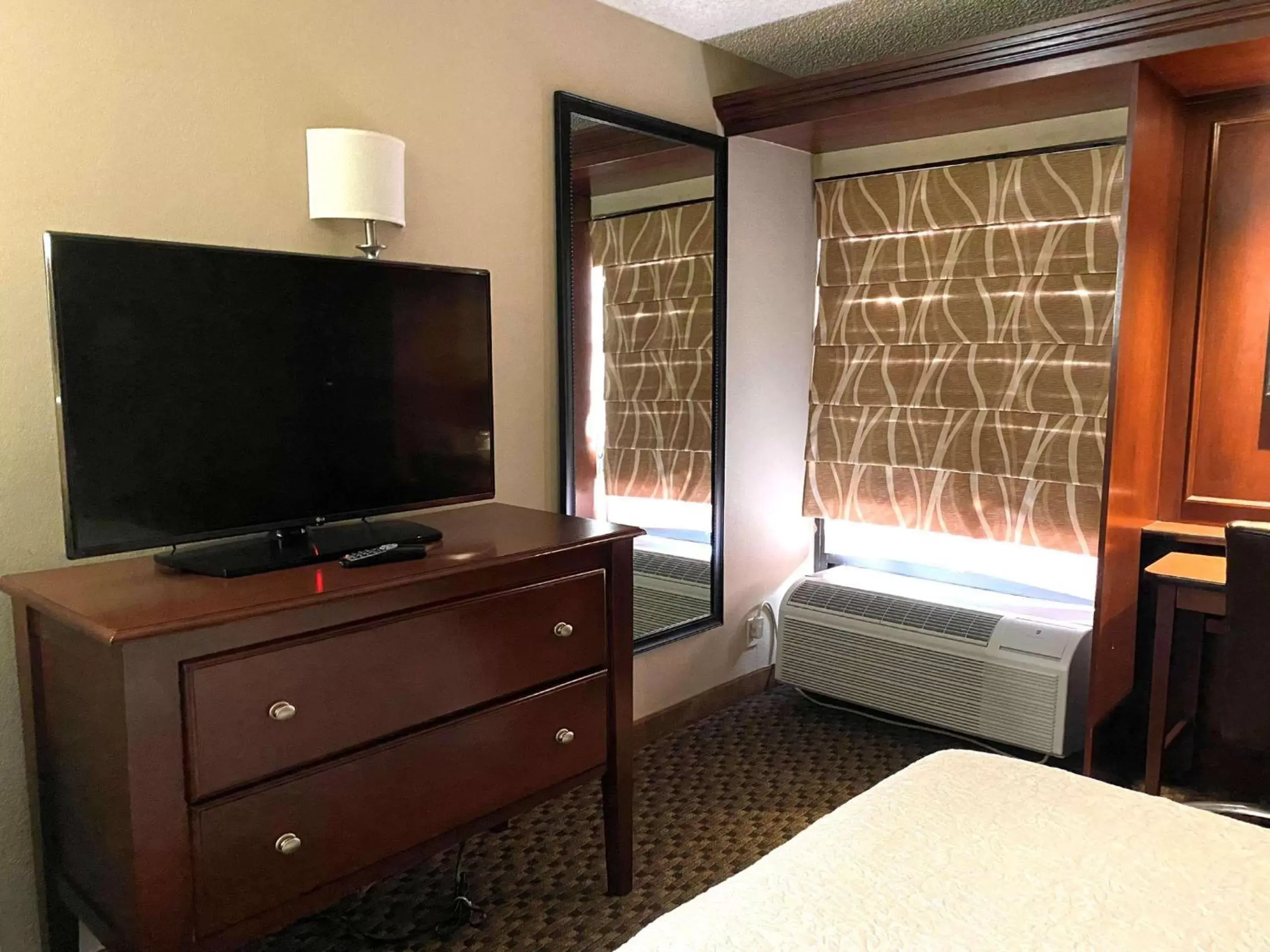 Bedroom, TV/Entertainment Center in The Addison Hotel SureStay Collection by Best Western