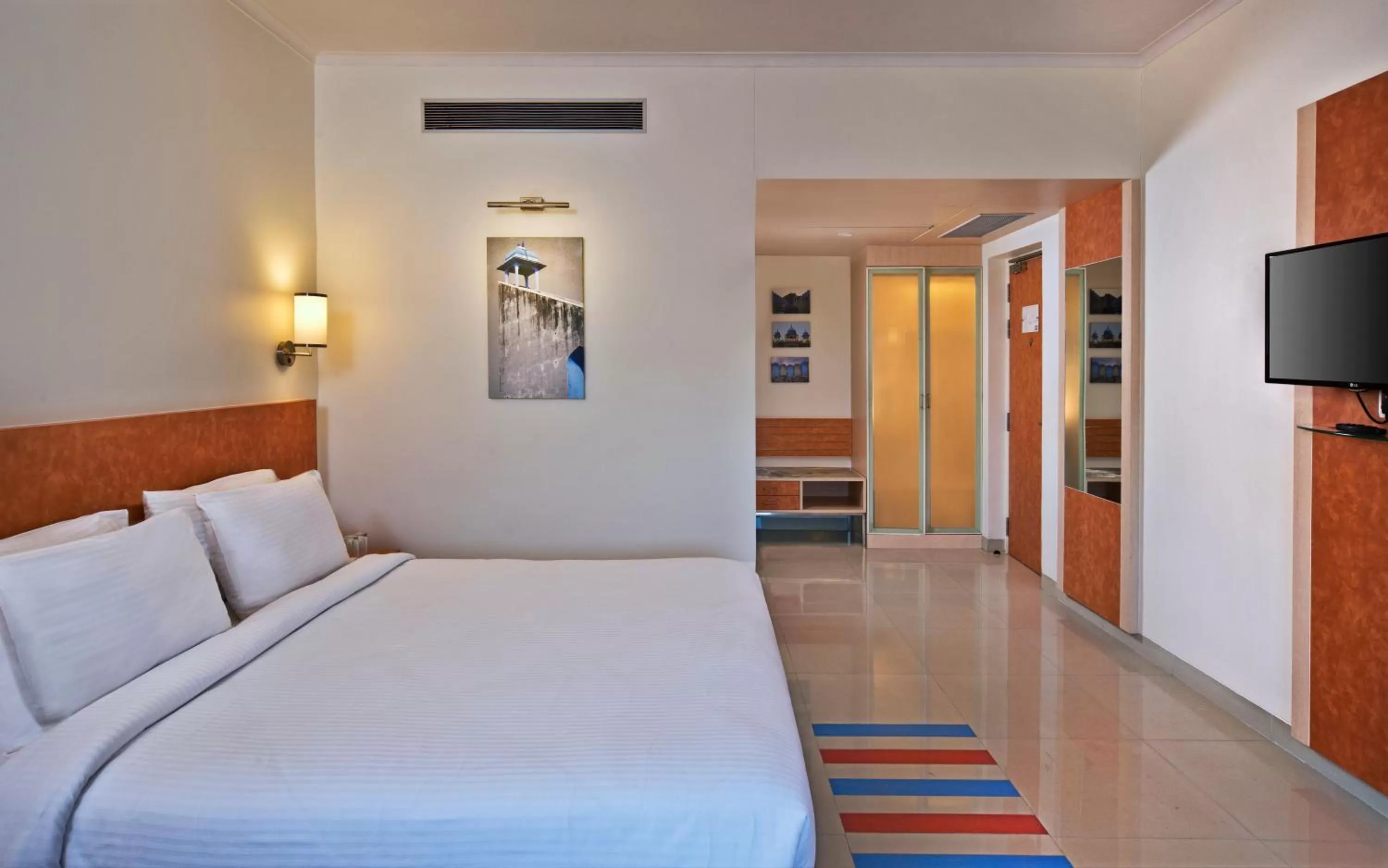 Bed in Nirwana Hometel Jaipur- A Sarovar Hotel