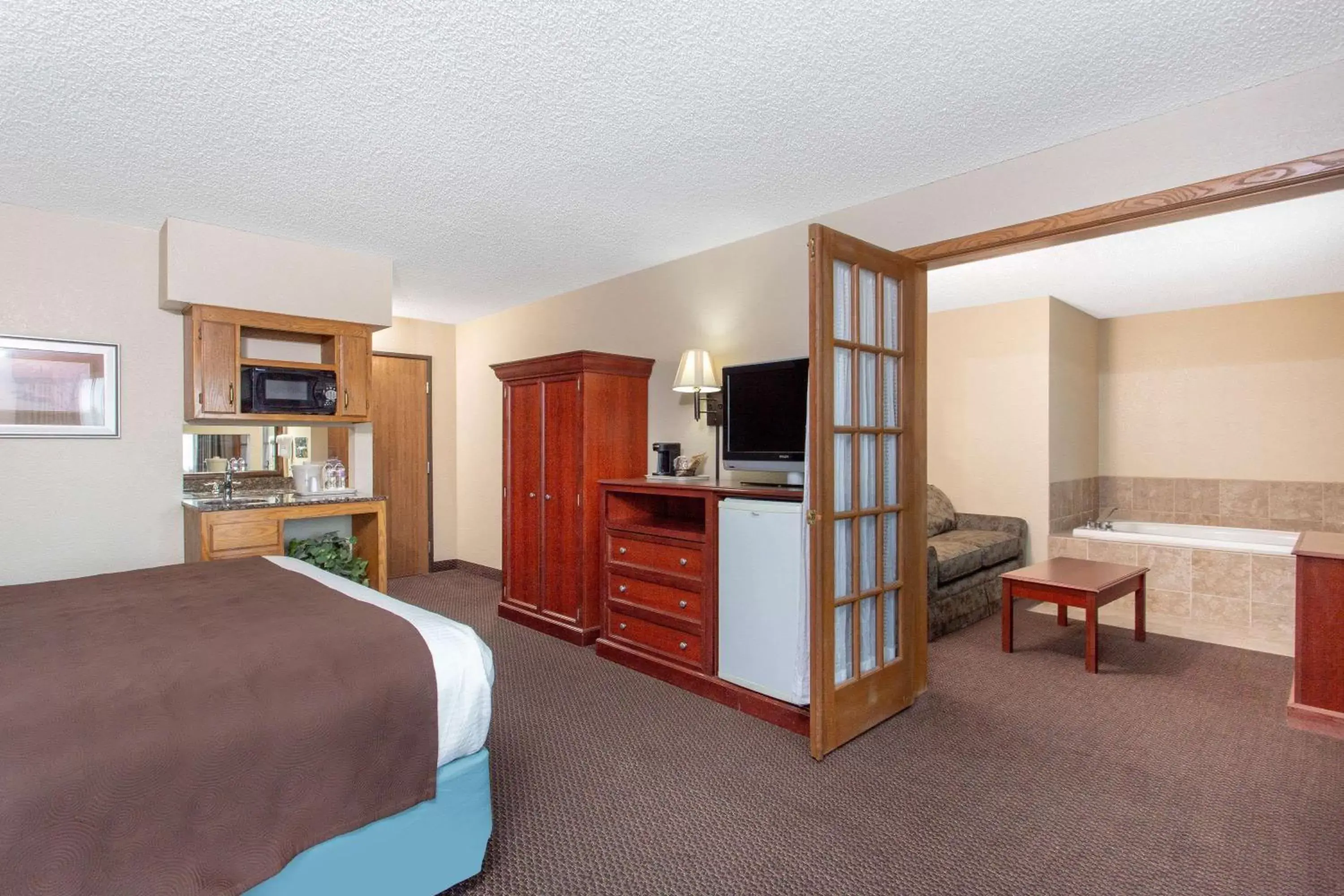 Photo of the whole room, TV/Entertainment Center in AmericInn by Wyndham Chippewa Falls