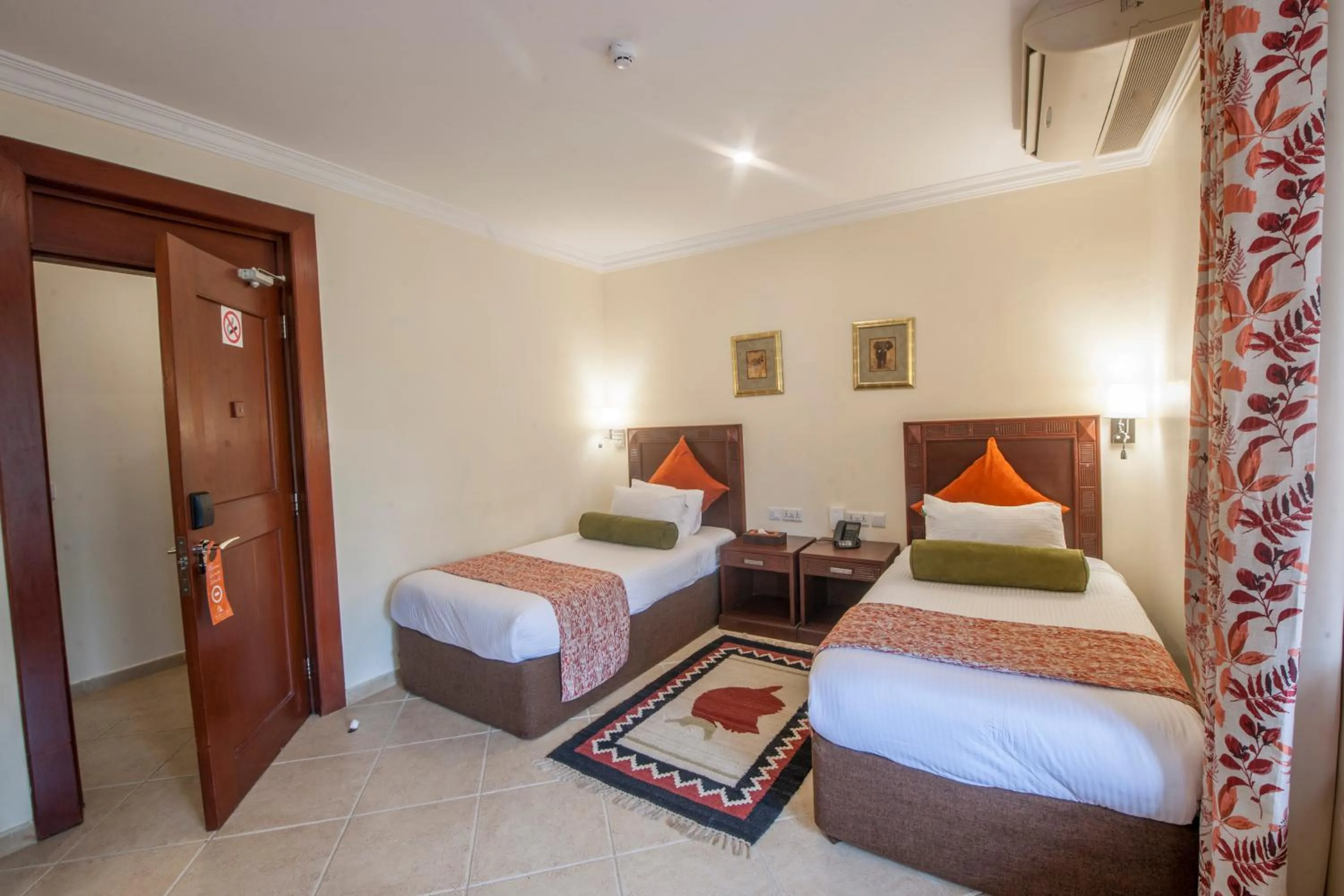 Bed in African Tulip Hotel