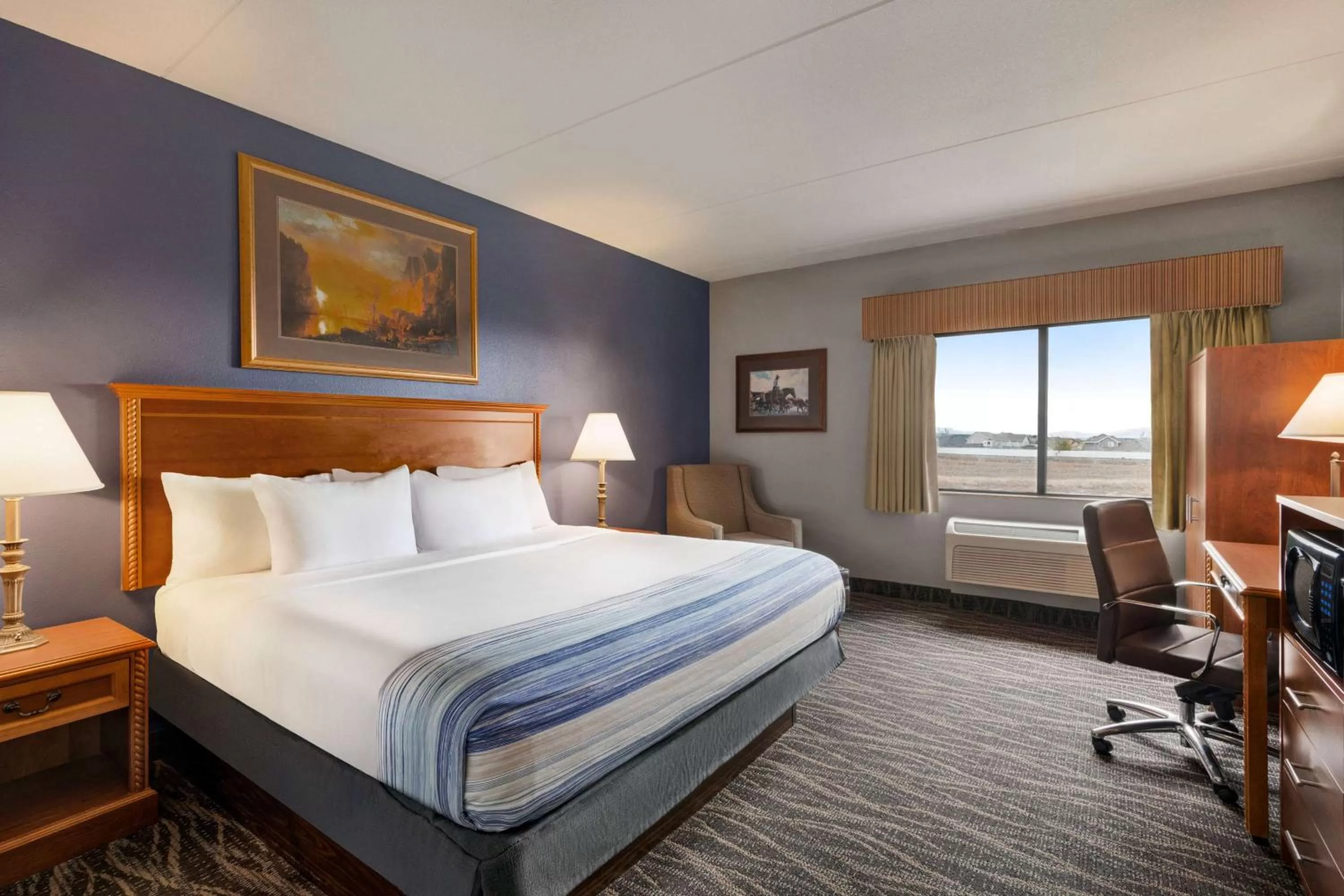 Bed in AmericInn by Wyndham Laramie Near University of Wyoming