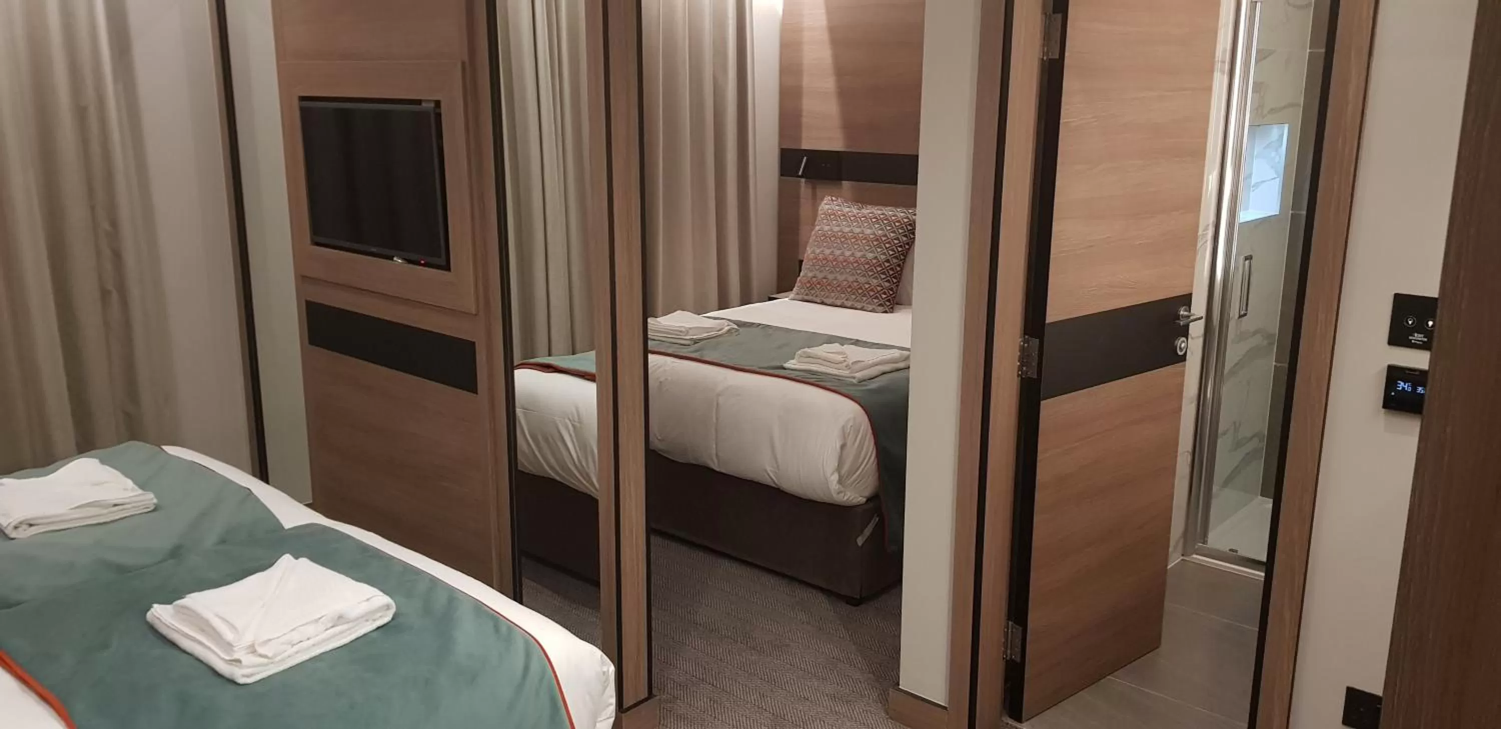 Bed in Merit Kensington Hotel