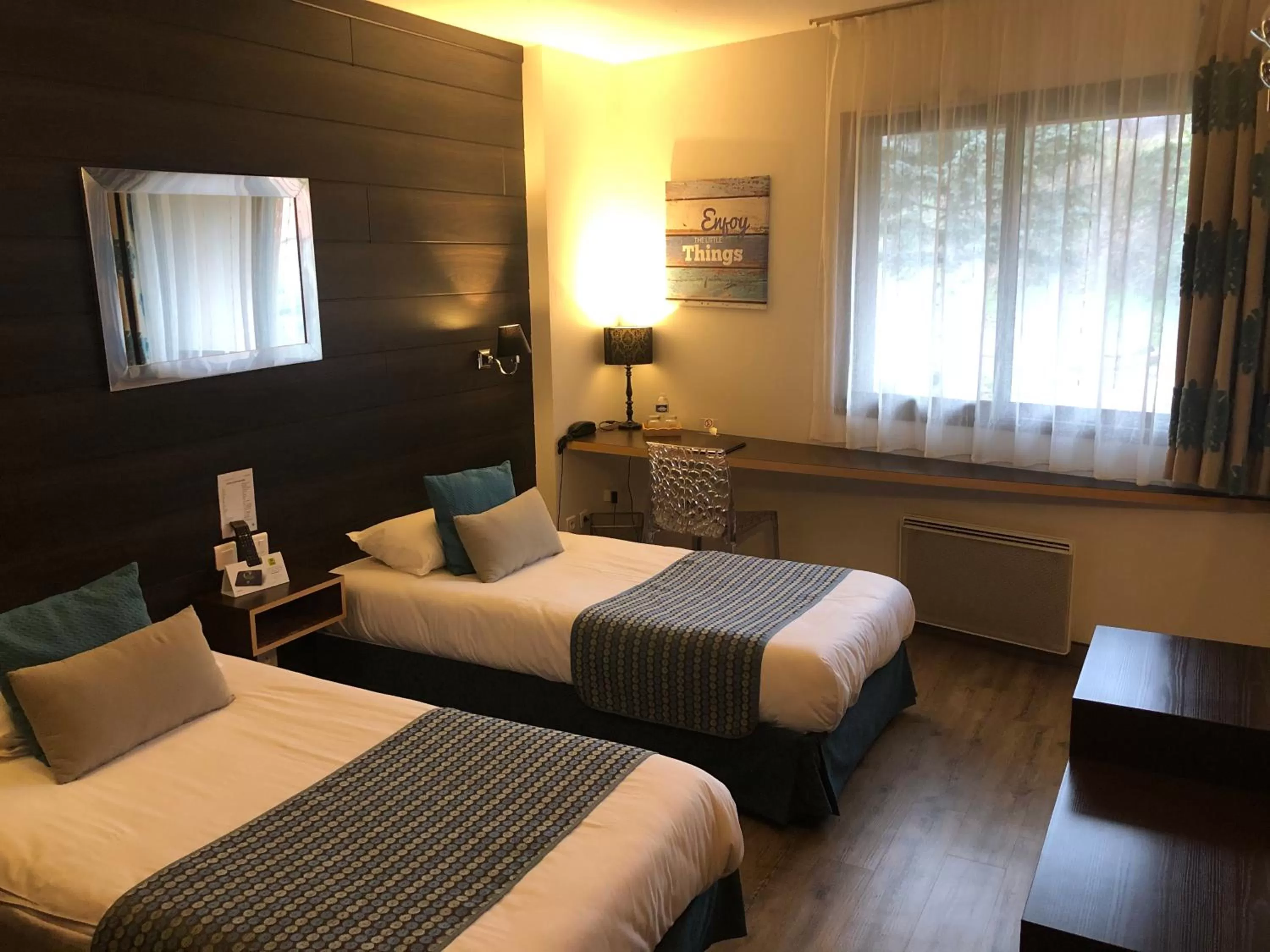 Bed in Logis Hôtel Burnichon