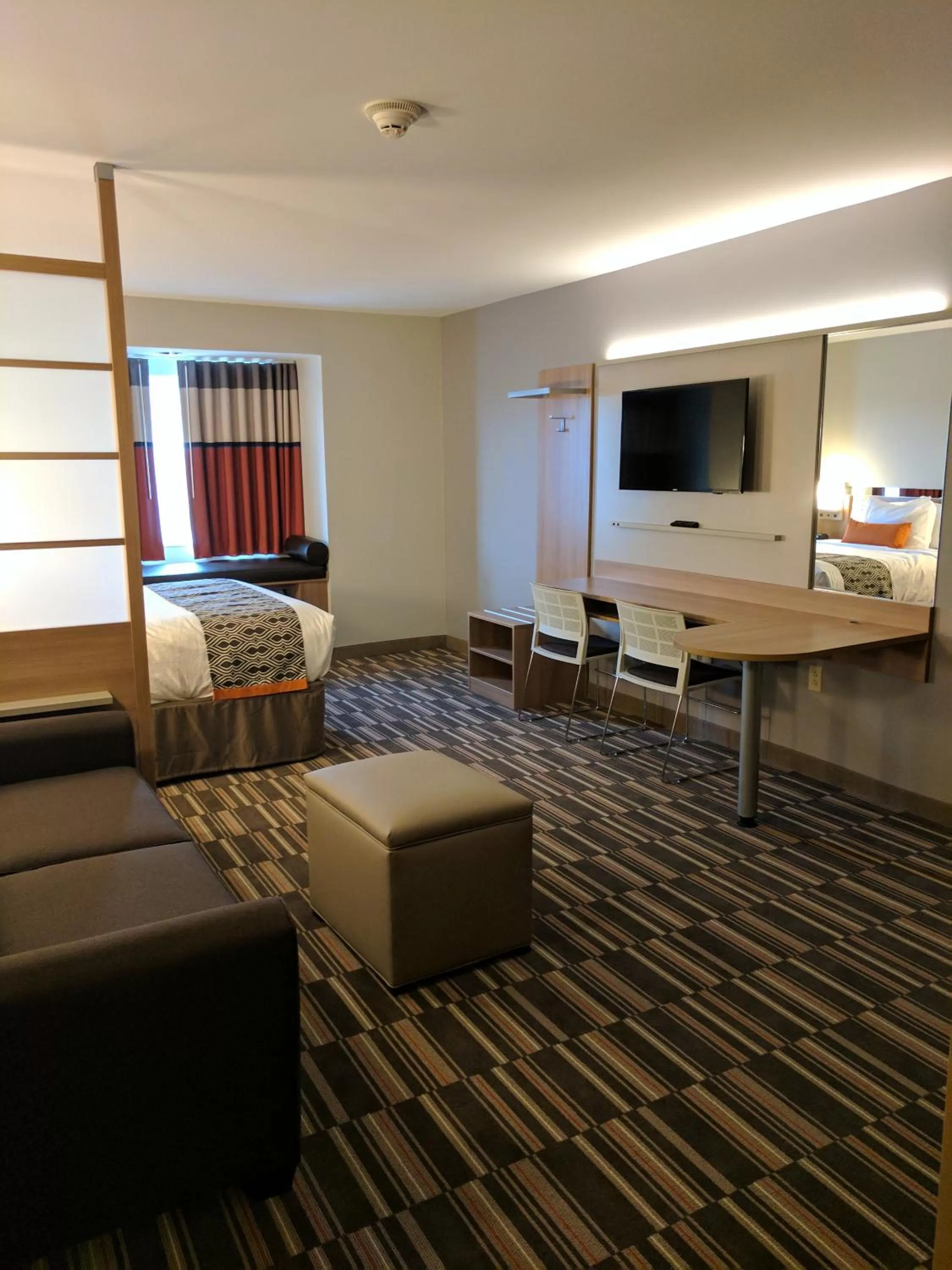 Living room, Bed in Microtel Inn & Suites by Wyndham Clarion