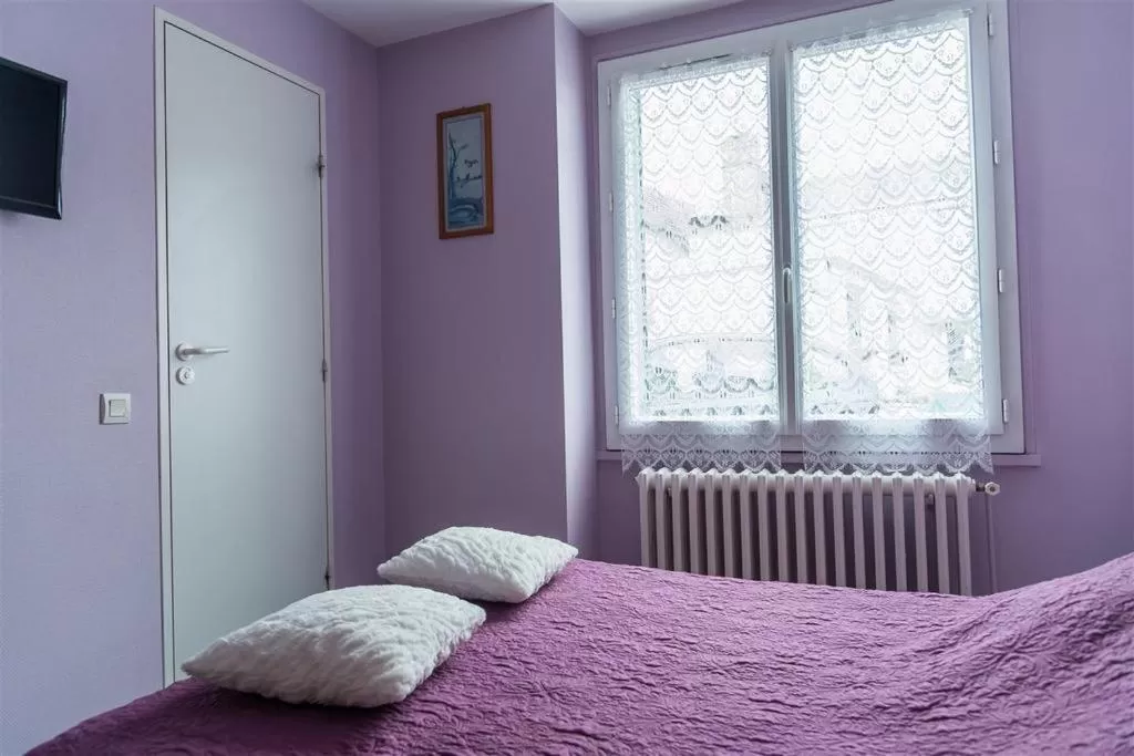 Bed in HOTEL DU CYGNE DE LA CROIX BLANCHE