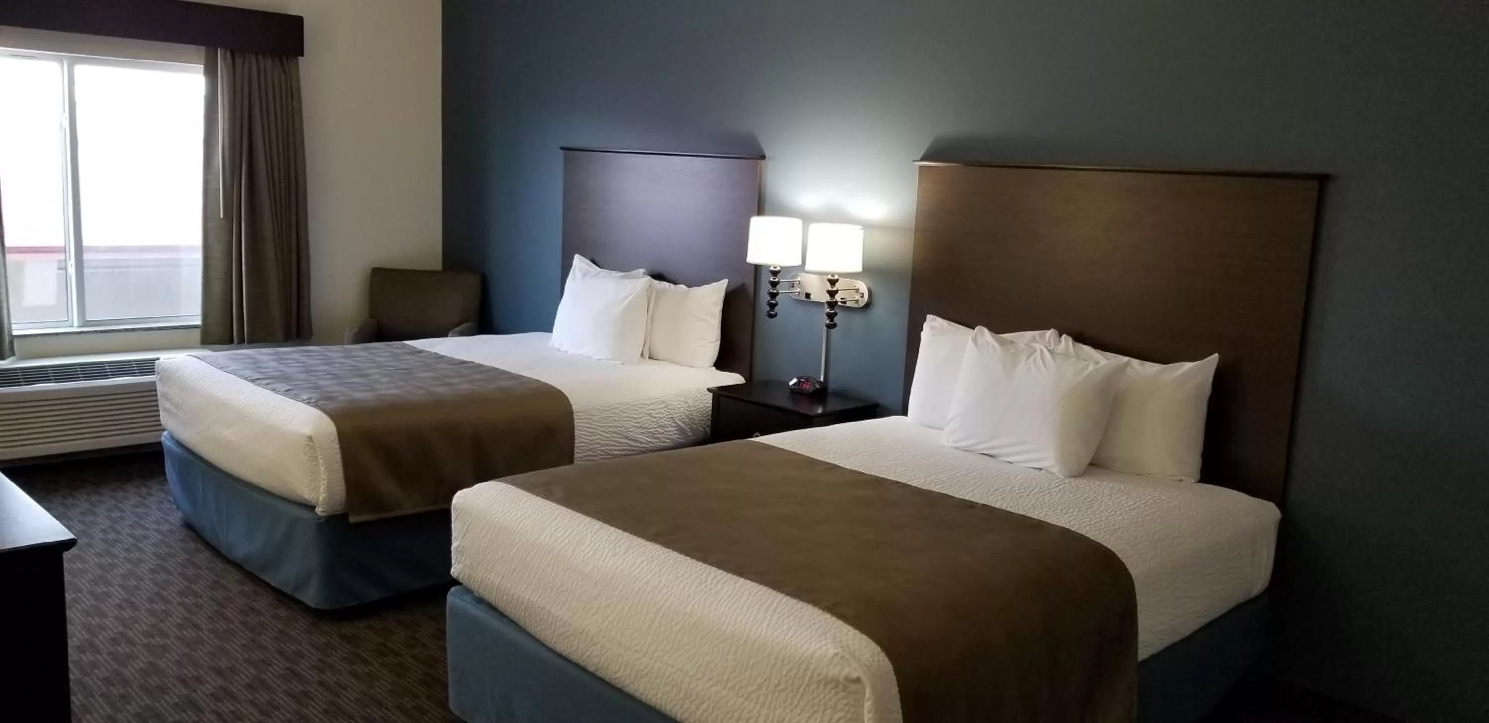 Bed in AmericInn by Wyndham Sioux Falls North