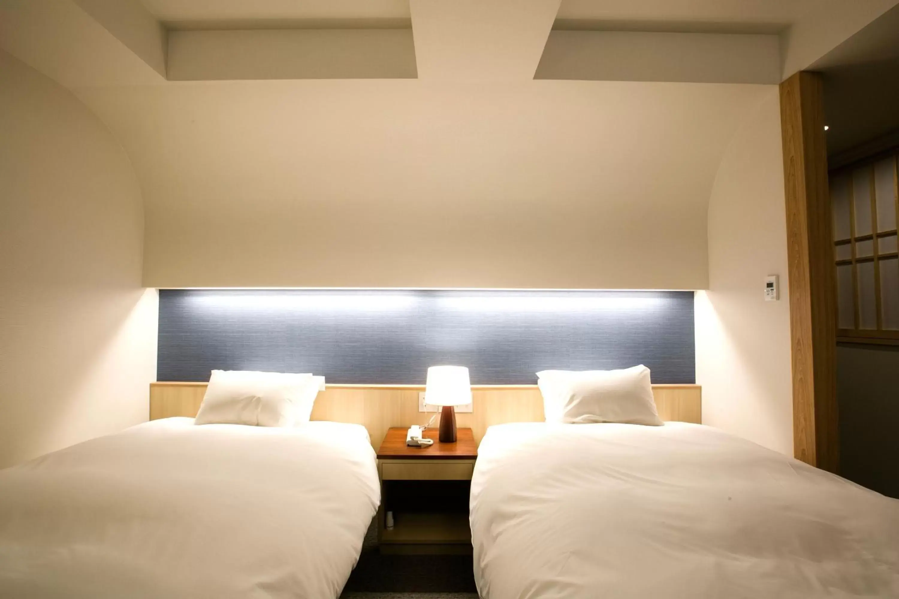 Bed in Kyoto Kamanza Hotel