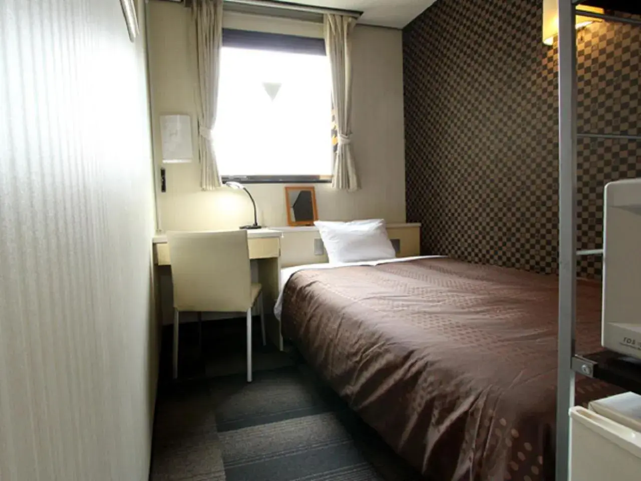 Bed in HOTEL LiVEMAX BUDGET Shinosaka