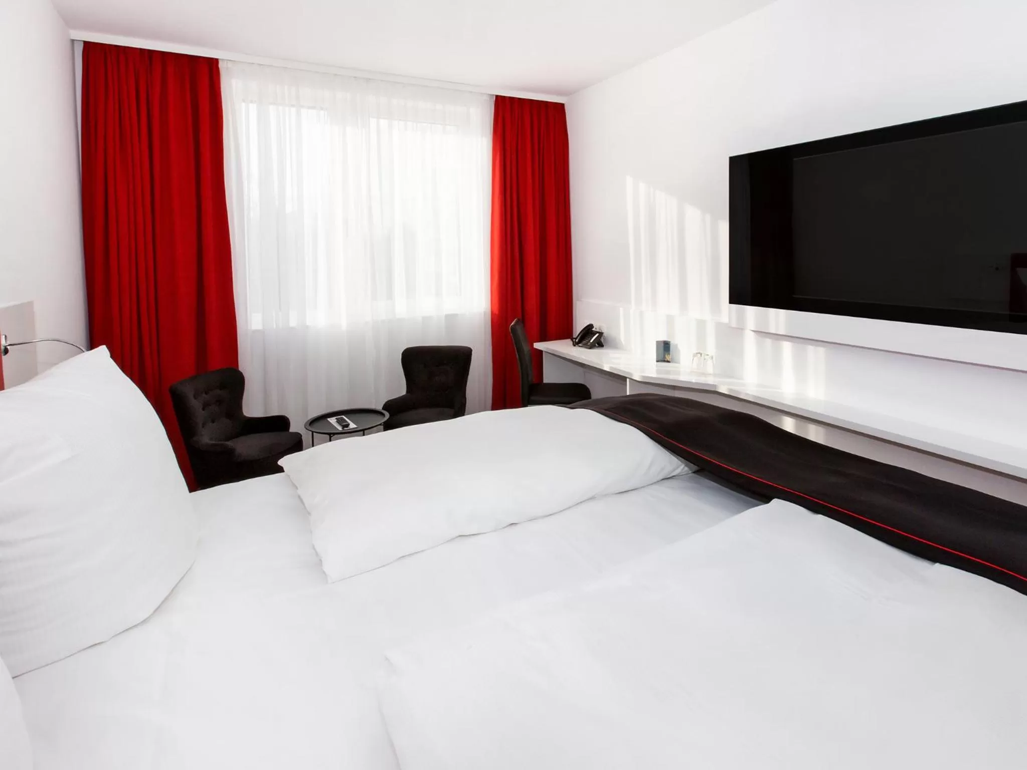 Photo of the whole room, Bed in DORMERO Hotel Zürich Airport