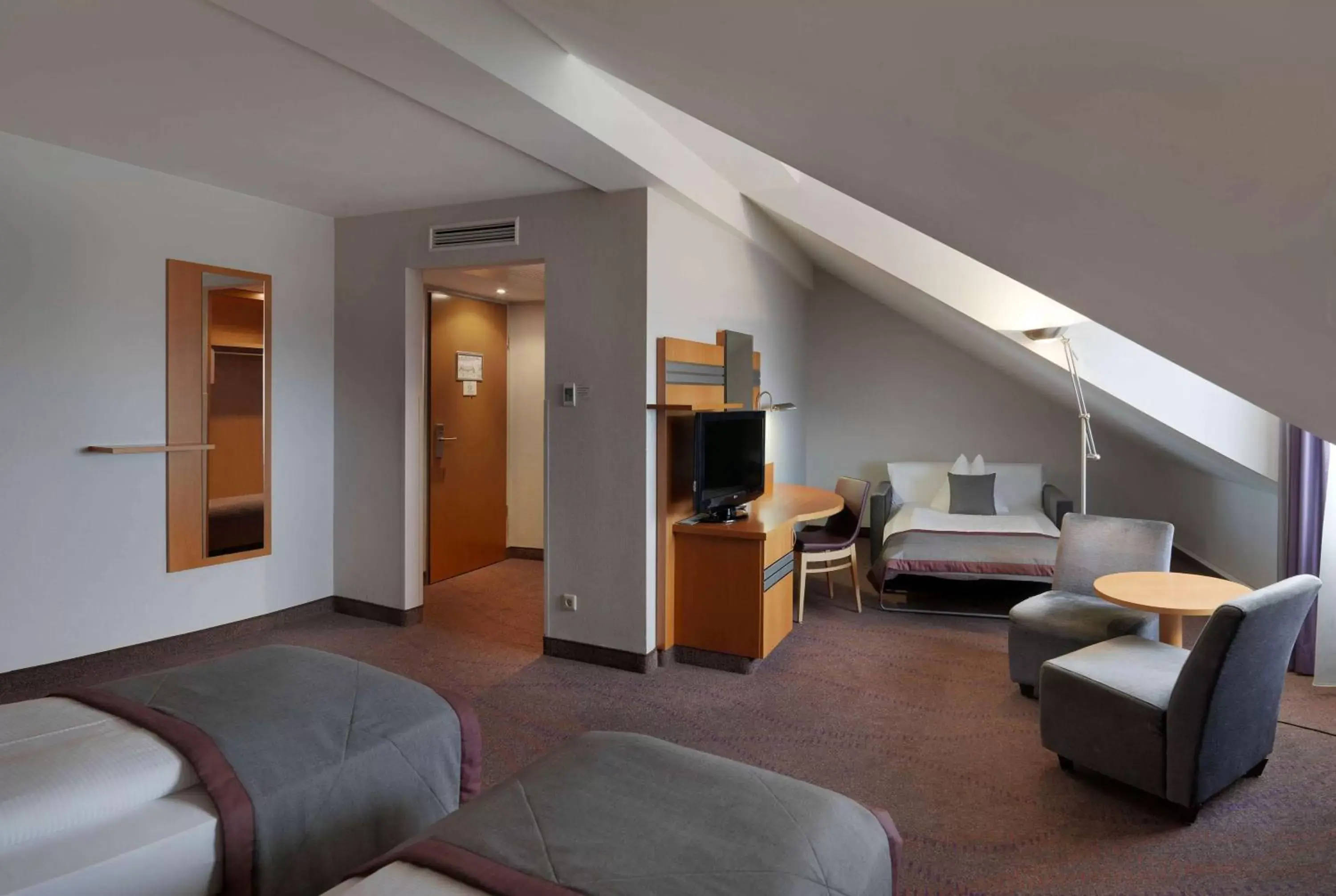 Bed, Seating Area in Ramada by Wyndham Dresden